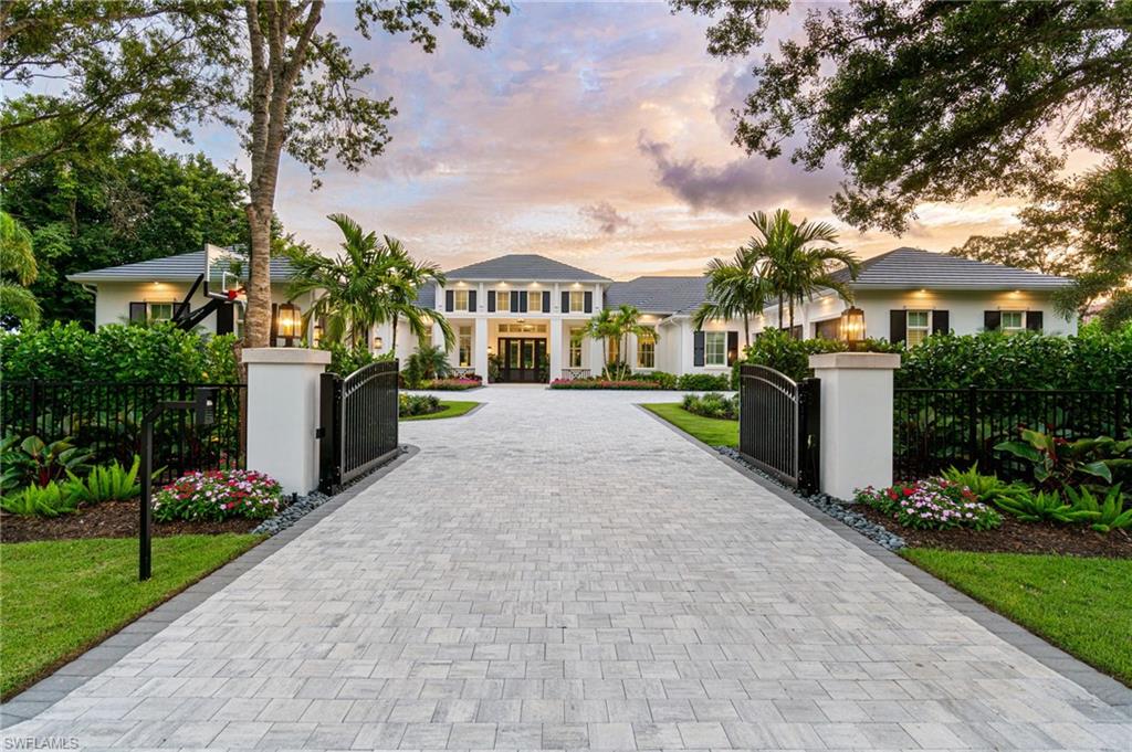 Welcome to 475 Carica Road, a custom estate where the charm of Naples meets the timeless allure of the Lowcountry. From the moment you arrive, this home captivates with its tall mahogany entry doors, grand porch columns, and classic shutters, all framed by mature shade trees and lush landscaping. Inside, the atmosphere is serene and welcoming, blending high detailed ceilings, soft neutral wood tones, and coastal accents for an ambiance of pure relaxation. Expansive windows invite abundant natural light to fill the space, creating a seamless connection with the beautiful surroundings. At nearly 6,800 square feet, this estate offers generous living spaces, including 5 bedrooms, a dedicated office, and a spacious bonus room. The Florida Room is a true highlight, bathed in sunlight and perfect for enjoying peaceful moments with nature. The soothing wall colors and subtle textures throughout add to the calm, peaceful vibe of the home. The heart of the home, the kitchen, features top-of-the-line Wolf and Sub-Zero appliances and a full butler’s pantry, ideal for both casual meals and elegant entertaining. A 5-car air-conditioned garage offers ample space and comfort. More than just a house, this estate embodies the spirit of the Lowcountry – a place where family, roots, and tradition are deeply valued. The attention to detail and craftsmanship make this home the perfect place to build your own  legacy.