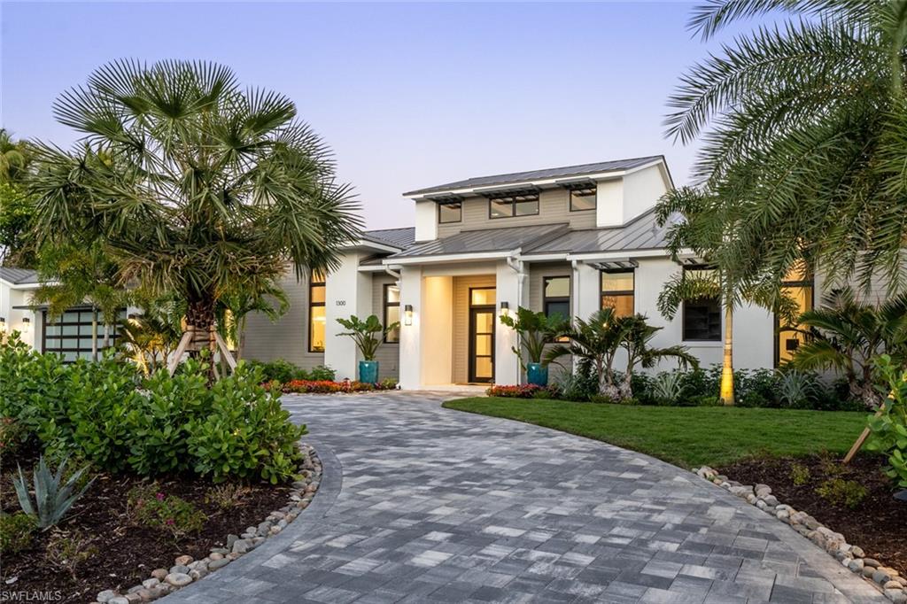 The Nautilus is an exacting definition of custom home design. Located on a huge corner lot, and a short walk to our beautiful white sand beaches. A modern coastal retreat drawn by architect Jonathan Kukk, AIA. Interior finish selections by Design West, and a bespoke furnishing and design package by Robert Brown of Atlanta. This A list of artisans collaborated in concert with Gulfstream Homes to execute one of the finest single level residences in Naples. 6,651 sq ft of luxurious and seamless indoor and outdoor living space. 5 bedroom suites and 5.5 baths all on one level with soaring ceilings reaching 21’ in the great room accented by stained white oak and unique cloud-style ceilings in guest rooms with LED back lighting throughout. Control 4 home automation with security cameras and a full electronics & audio package. Fine cabinetry and built-ins crafted by Ruffino Cabinetry. Legno Bastone white oak floors throughout and large Andersen windows pour in natural light. Pocketing slider door systems collapse to integrate the outdoor living with natural shell stone decking and roll down screens, all created by Architectural Land Design to complete this tropical oasis. Flood Zone X!