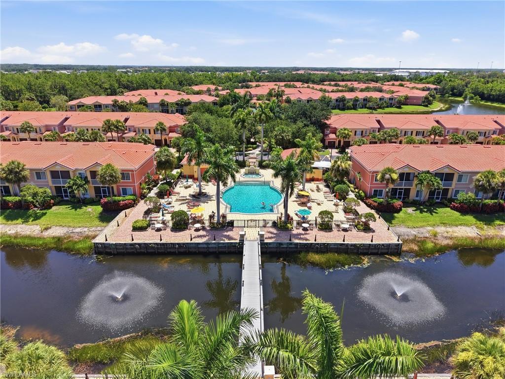 This large, 2nd floor unit is situated in the center of Villagio, giving access to the amazing amenities, just steps from the front door! A huge primary bedroom and bathroom, with dual sinks, separate shower and tub, and two closets, gives space to live comfortably. Two additional nicely sized guest bedrooms share a bathroom, and the den is large enough to accommodate guests as well! Beautifully updated vinyl plank flooring throughout, with impact glass windows and sliders. Take in the view from the balcony, with the lake and fountain, and the community resort style pool all part of the scene. Storage is usually tough to find in a condo, but this home has multiple closets, a pantry, and a one car garage, to meet your needs. A well laid out kitchen with granite countertops is in the middle of the home, so you won't miss a thing when entertaining. So much value and room to move in this home and community! The monthly HOA fee includes  the Xfinity X1 cable package with DVR and high-speed internet, interior AND exterior pest control, water, landscaping, and more. 24-hour gated security will give you peace of mind, plus within the gates, you will find so much to do! Brand new tennis courts and pickleball, two pools, a hot tub/spa, and a large fitness center will keep you active, while the community town square will help you relax! On site property management, a cafe serving a full menu (including ROYAL SCOOP ice cream), beautifully landscaped grounds, even a movie theater! Located just to the west of I-75, Gulf Coast Town Center, Hertz Arena, multiple shopping, dining, and entertaining options surround this community!