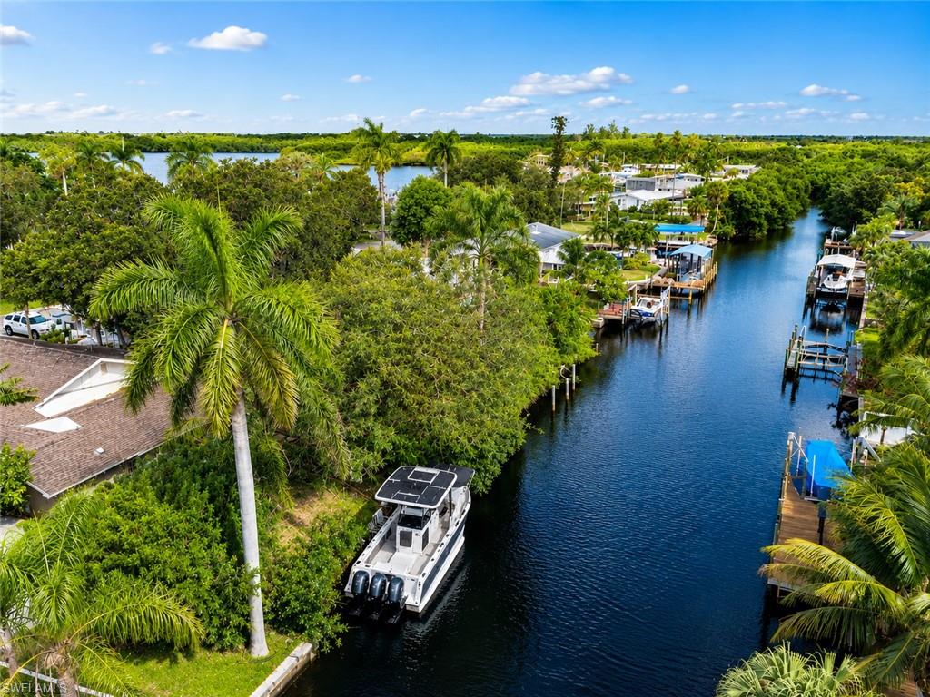 Picture morning coffee on the patio as manatees drift down your own canal and birdsong carries over from the park across the street. Move-in-ready, fully renovated waterfront home in one of Fort Myers’ most characterful pockets. Tucked behind the main house is a fully permitted studio apartment, ready for guests, multigenerational living, or rental income. This is the rare Florida canal home where the work is already done, the big-ticket systems are brand new, and the lifestyle starts the day you move in. 

Renovated top to bottom: a brand-new kitchen with GE Profile appliances and an LG refrigerator, all-new bathrooms, fresh bi-color designer lighting, ceiling fans, and chandeliers throughout. Sealed travertine stone flooring runs through the home for a clean, cohesive look. All-new faucet fixtures and showers; Moen garbage disposal; an electric fireplace with heat & no-heat modes. A bonus room that easily converts to a fourth bedroom.
Central heat and air conditioning in the main house. Entire home rewired with a new electrical system (2025), plus
whole-home surge protection installed at the meter (owned, not leased). Six impact-resistant exterior doors (Window World) and hurricane shutters for storm season. New gutters (2026), and a new hot-water
heater (2024). Directly across from Russell Park, a neighborhood bird sanctuary; cardinals,
blue jays, woodpeckers, herons, hawks, even wild parrots. A mature, fruit-bearing landscape: mango, lychee, Marcus pumpkin avocado and Oro Negro avocado trees, two oaks, and royal palms along the canal. An almost fully shaded, fortified-privacy backyard with two patios and full perimeter fencing.


This home is just minutes from I-75 giving you the ability to quickly travel to other attractions such as Fort Myers Beach, Sanibel Island, and all the shopping, dining, and entertainment of downtown Fort Myers. Unlike central Cape Coral, this property provides easy access without the traffic congestion. 

Airbnb, Short term rental, VRBO, Vacation Rental, STR.