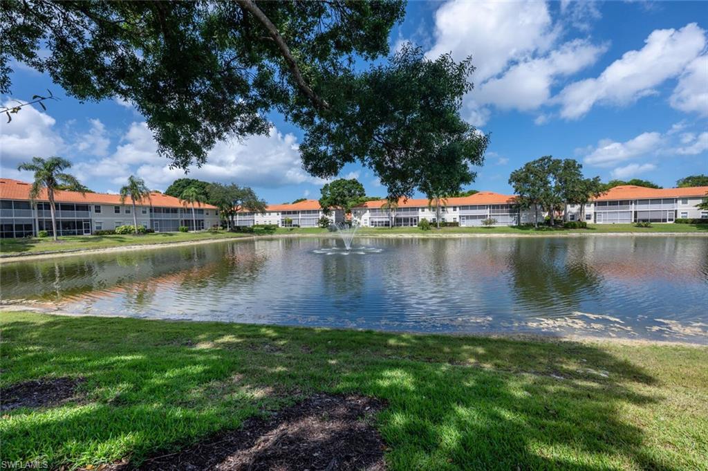 Ideally situated in the heart of Central Naples, this residence is located within Pipers Grove, one of the area’s desirable communities, known for its exceptional amenities. This bright and elegant second-floor end-unit condominium offers nearly 1,600 square feet of thoughtfully designed living space, featuring two bedrooms plus a den and two baths. Volume ceilings and abundant natural light create an airy, refined atmosphere throughout. Enjoy southwestern exposure and breathtaking sunset and lake views from the private screened lanai, overlooking one of the most picturesque water vistas in the community. A desirable split-bedroom layout provides privacy for both owners and guests. The serene primary suite features dual closets, including a generous walk-in, and calming lake views. An open loft-style den with pocket sliding doors, and closet offers flexible living or office space. The spacious, windowed entryway includes a large storage closet, ideal for additional space. Recent enhancements include laminate flooring throughout, a recently replaced A/C system, and a 2019 roof replacement, as well as  electric storm shutters on the lanai that offer protection and peace of mind from approaching storms. Covered carport parking and ample guest parking are included. Conveniently located three miles from Naples’ renowned beaches convenient to many dining and shopping venues.