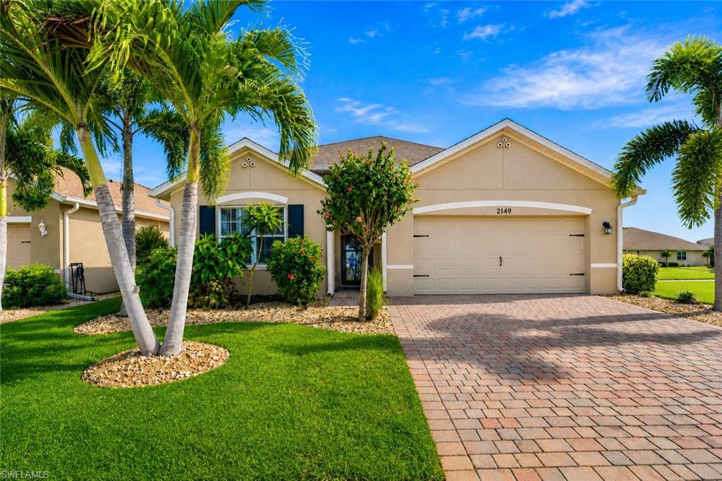 MODERN UPDATES, A PRIME LOCATION, AND MOVE-IN READY! Ideally situated on an oversized corner homesite near the community entrance and resort-style amenities, this beautifully updated home offers the perfect blend of comfort, convenience, and low-maintenance Florida living. Thoughtfully maintained and extensively updated, you'll appreciate the peace of mind that comes with a NEW AC system (2025) with a transferable warranty and UV air purification light, NEW CLEAR STORM PROTECTION with inset TRACK, NEW laminate flooring (2025) with enhanced underlayment in the bedrooms, NEW stainless steel kitchen appliances (less than one year old), interior paint (2025), and exterior paint (2026), widened driveway and upgraded landscape. Hard-surface flooring extends throughout the home.  The open-concept kitchen, dining, and great room create an inviting space for everyday living and entertaining, while the kitchen features 36" upper cabinetry, granite countertops, a spacious island, and a Stainless-Steel Appliance Package less than ONE YEAR old. Natural light fills the home, enhancing the bright and airy floor plan, while the privately situated primary suite provides a peaceful retreat. Step onto the lanai to enjoy a relaxing water view, creating the perfect spot for morning coffee or unwinding at the end of the day. Additional upgrades include newer lighting, ceiling fans throughout, a decorative front storm door that welcomes additional natural light, electric landscape lighting, an EPOXY finished garage floor and convenient attic access with pull-down stairs for additional storage. Enjoy Magnolia Landing's exceptional amenities, including a resort-style pool, dedicated lap pool, state-of-the-art fitness center, pickleball, bocce ball, shuffleboard, and a full calendar of community activities. Optional golf memberships provide access to the championship 18-hole golf course, complete with a golf shop and on-site restaurant. Enjoy LOW HOA's that include Lawn/Landscape care, CABLE package, irrigation, and access to amenities (golf not included.)  Beautifully updated, ideally located, and thoughtfully maintained, this exceptional home offers the perfect opportunity to enjoy everything Magnolia Landing has to offer. Start living the Florida lifestyle you've been dreaming of today!