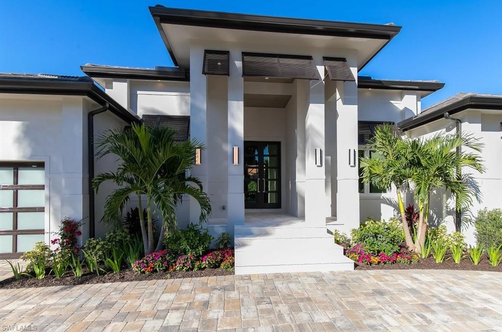Premier Moorings new construction located west of Crayton Road. This tastefully designed home by RL Keith Architects is a Coastal styled one story home constructed by TradeMark Development Group.The home is 5100 SQ FT of total living space with 3600 SQ FT under air. This floor plan includes 4 bedrooms including the fabulous master suite with oversized his and her closets and access to the adjacent laundry room.  The home a pool bath as well as an additional powder room. The entry leads to the grand 15 foot foot tall great room that features a beautiful two sided gas linear fireplace that is shared with the adjacent office/sitting room. The kitchen has custom cabinetry with Thermador Professional Series appliances, as well as an adjacent private work area. The oversized lanai, pool and outdoor kitchen is fabulous. The garage has 12 foot ceilings with high lift doors to comfortably accommodate auto lifts for a car enthusiast. Other outstanding features include Legno Bastone flooring, tongue and groove ceilings, a 500 gallon propane tank, duel tankless hot water system, Crestron lighting, remote shutters and screen system, central alarm, central vacuum, beautiful wine storage area .