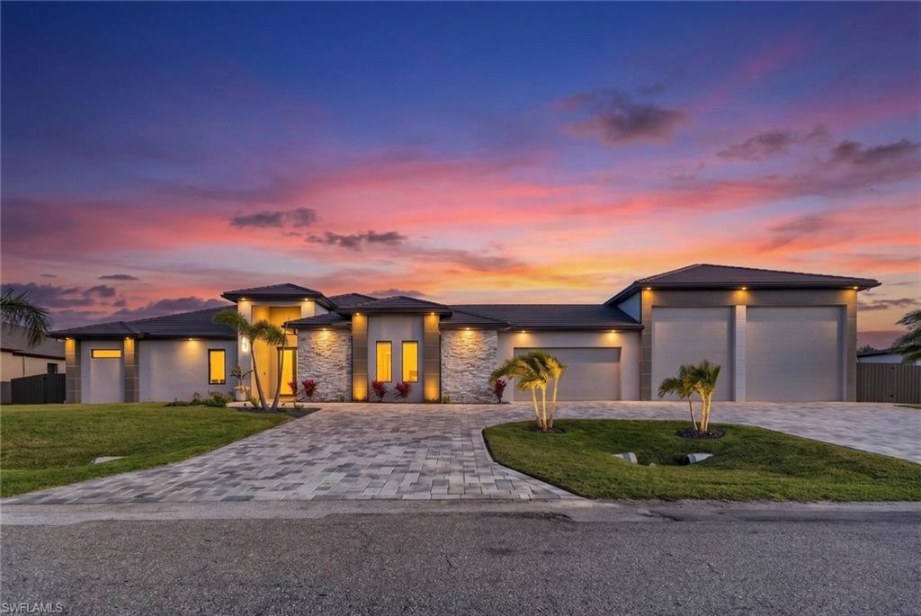 2024 Custom-built luxury home on the Water with Gulf access, featuring a massive 2-RV garage, measuring 65' L x 30 ' W, making it ideal for RV owners, boat storage and car enthusiasts. This garage can fit one RV, plus 1 36' boat, or 1 boat and 5 cars. the home provides 3,500 square feet under air with 4 bedrooms, an office, a home theater and 6 baths. The property includes a private newly constructed grey composite dock with a large canopy, a custom fish cleaning table, and a heavy-duty boat lift up to 36 feet. One of the home's most desirable features is a huge 23' x 17' home theater with a high-quality surround sound system, screen projector, bar with quartz countertop, mini fridge, microwave, custom European cabinets and 2 big closets with shelves. A panoramic picture-window screen enclosure maximizes canal views without visual obstruction. The kitchen offers quartzite countertops with a waterfall island, a huge walk- in pantry with shelves, custom cabinetry, high-end fixtures and several closets throughout the home. High-quality, large porcelain tile throughout all bathrooms. Wired speakers (two inside and 3 outside) provide an integrated entertainment experience. Wire security cameras all around home, situated on an oversized .0.48-acre, Gulf access canal lot, this remarkable residence offers a total of 6,542 square feet under roof. The stunning outdoor living area includes a HUGE swimming pool around 50' L x 16'w with heated pool and spa, outdoor shower with cold/hot water, travertine deck, irrigation system, exterior lighting, and covered lanai, also features are new remote-control hurricane shutters. The expansive lanai along with a full outdoor kitchen, equipped with gas stove, extractor hood, ice maker and beer machine, refrigerator, double oven and two mounted televisions. whole-house reverse osmosis RO system, 6 fans with remote control, Kids Park area with turf and powerful solar lights This property combines, unique modern design, quality construction, and a prime waterfront setting to deliver a refined and distinctive waterfront living experience Minutes to Coral Oaks and Royal Tee golf courses, Publix, and the future 7 Islands waterfront dining and shopping district. Impact doors and windows, grey tile roof showings for SERIOUS buyers only!