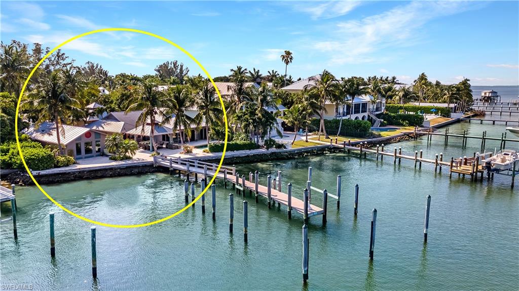 Captiva Village Bayfront compound situated in the sought after Bayfront deep-water area; this private flag lot compound offers the widest lot and seawall frontage on this quiet street. Sunrises, Moonrises and expansive Pine Island Sound views. Property offers an 85 ft. long, deep-water, direct access dock w/water, electric, lighting, accommodating both a large boat and a smaller boat. This 5-structure Bayfront compound includes: 3 BR/3 BA main house; 1 BR/1 BA guest cottage, studio used as office/exercise/game room, all with views of the Bay. Detached oversized 2-car garage and carport for golf cart storage. Patio area with large, roofed gazebo and heated saltwater pool are perfect for entertaining friends and family. Surrounded by lush tropical landscaping, the property has potential to accommodate a large newly constructed home. This private, remodeled, compound in the “Village” area is just a short stroll to the Gulf of Mexico beaches, shopping and restaurants.