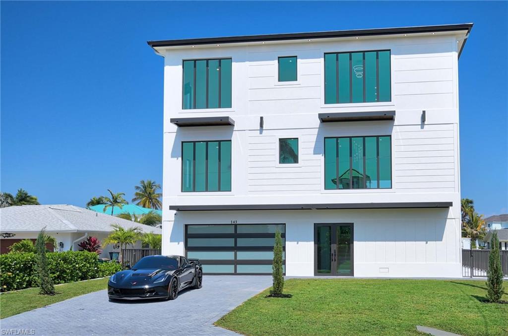 Welcome to 143 Trinidad St.  A brand new, exquisite residence that offers unparalleled comfort, style, & elegance. Features 5 bedrooms & 4 bathrooms spread across more than 4,200 Sqft of living space with elevator access to all 3 levels. This stunning property boasts a spacious layout that is perfect for large families, couples, & anyone who values coastal living. Built to last forever with cement block construction from the ground up, hurricane impact windows, doors and sliders, topped off with a standing seam aluminum roof. The 1st floor has over 2,000 sq ft of garage & storage space that leads out to the big, heated swimming pool & spa with a cascading waterfall from the deck above, the dock & boat lift. The 2nd floor is so big it lives like another house.   Features include a big living room, full kitchen with a big island, a laundry room, 3 bedrooms, 2 baths and a large open floor plan living area, that is excellent for entertaining guests or relaxing with family.  The living area boasts vast windows that provide beautiful views, lots of light & a large covered balcony. 
The 3rd floor is where you will find the heart of the home along with the master bedroom & bathroom. The kitchen on this level is a chef's dream, featuring high-end appliances, an oversized island, & plenty of counter space for meal preparation, complete with a big, beautiful wine rack. Features include another huge living room, guest bedroom & bathroom and another laundry room. This lavish suite is the great place to retreat after a long day, offering ample space & impressive amenities. The master bathroom features a big shower, a double vanity and a huge walking closet. Another big balcony with even better views is on this level with a private staircase leading you to the roof top observation deck.  The views from there are unparalleled, providing 360 degree,  breathtaking views of the Gulf of Mexico, 10,000 islands & Marco River, making it the perfect place to unwind & take in the beauty of the surrounding area. The brand new seawall, dock and boat lift offer quick, Direct-access to the Gulf.  You will see lots of Dolphins, Manatees, birds and other wildlife behind the house, on a daily basis.  This property is the epitome of luxury island living.