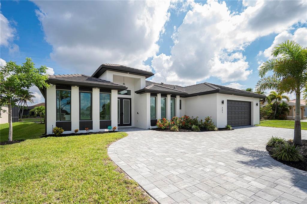 CUSTOM-BUILT 2024 WATERFRONT ESTATE | PROPANE GAS COOKING | TILE ROOF | CIRCULAR DRIVEWAY 
Tired of cookie-cutter spec homes? This exceptional custom-built 2024 waterfront residence stands apart with more than $150,000 in premium structural and luxury upgrades rarely found at this price point.
Designed for both elegance and durability, the home is constructed on a 3-course stem wall for enhanced elevation and peace of mind, and is topped with a long-lasting tile roof. Impact-resistant windows and doors throughout provide security, energy efficiency, and storm protection without the hassle of shutters.
A rare buried 60-gallon propane system fuels the chef’s kitchen, outdoor summer kitchen, and offers the option for future gas pool heating. Inside, the gourmet kitchen showcases granite countertops, a dramatic waterfall island, soft-close wood cabinetry, under-cabinet lighting, and premium finishes throughout.
The thoughtfully designed floor plan features four bedrooms and three full baths, including a private mother-in-law suite or second primary suite with direct access to the lanai and pool area.
Step outside to your own private resort. The expansive screened lanai features a custom saltwater pool and spa with waterfall feature, picture-window screen enclosure, and premium marble paver deck. Entertain effortlessly with the fully equipped outdoor kitchen complete with grill, refrigerator, ice maker, wine cooler, and ample seating space under truss.
Additional highlights include a stately circular driveway, oversized three-car garage with 8-foot doors, 16-SEER HVAC system, R-38 insulation, tinted windows, and EV charger readiness.
Situated on a freshwater canal with a concrete dock, you'll enjoy kayaking, fishing, and peaceful waterfront views right from your backyard. Best of all, there are no HOA fees and no gated community restrictions.
Reproducing a home with these specifications—including the tile roof, stem wall construction, propane gas system, marble paver pool deck, circular driveway, and custom upgrades—would cost substantially more in today’s market.
This is a rare opportunity to own a truly custom waterfront estate where quality craftsmanship and thoughtful design are evident at every turn.