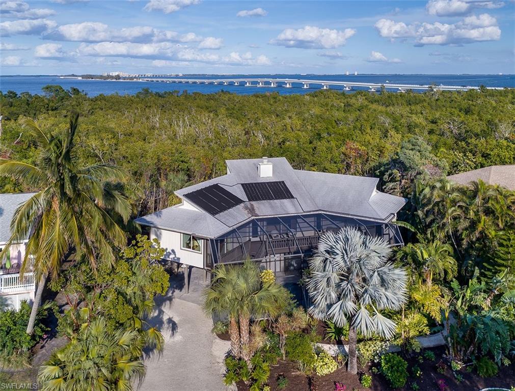 Sanibel retreat nestled among native vegetation in The Dunes steps to the country club. Roof, a/c duct work, w/d, water heater, pool heater, solar pool heater, flooring, out door decking and railing and other upgrades in 2019. A unique pool home.