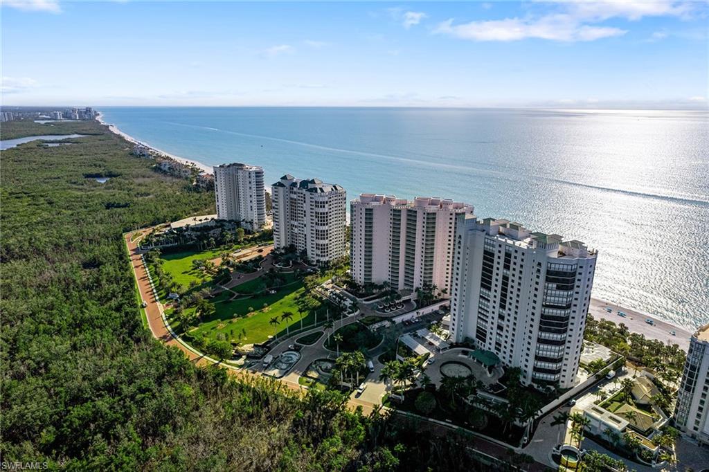 Lowest-priced beachfront residence in The Biltmore at Bay Colony, virtually staged for design inspiration. Experience luxurious coastal living in The Biltmore at Bay Colony, Naples premier gated beachfront community. This elegant three-bedroom plus den, 3.5-bath condominium offers panoramic Gulf views from three screened lanais. The residence features timeless marble floors throughout, a fully remodeled gourmet kitchen with high-end appliances, and custom designer finishes. The flexible den includes a stylish TV and fireplace accent wall, an adjacent laundry room and powder room, and all bedrooms offer en-suite baths for optimal comfort and privacy. Enjoy breathtaking sunrises and sunsets, Gulf breezes, and resort-style amenities such as two under-building garage spaces (#30 & 39) a climate-controlled storage room with electric (#72) ideal for charging e-bikes, plus access to a resort-style pool, spa, bar and BBQ area, 24-hour front desk, fitness center, sauna, billiards and social lounges, guest suites and a newly renovated lobby. Exclusive resident access to the Gulf-front Bay Colony Beach Club includes fine dining, full-service beach concierge, and a top-tier tennis center. Residents also enjoy two additional beach clubs with dining, wellness centers, kayaking, sailing, pickleball, tennis centers and tram service at Pelican Bay. Optional memberships to Bay Colony Golf Club and Club Pelican Bay offer championship golf. Minutes from Mercato, Waterside Shops, Venetian Village and 5th Avenue South, this property combines luxury, lifestyle and location, making it the best beachfront value in Naples.