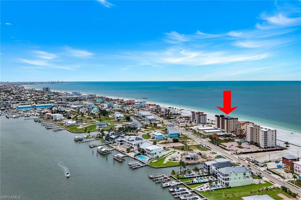 Experience breathtaking beachfront living from this beautifully renovated corner residence at Dolphin Watch Condominiums on Fort Myers Beach. Perfectly positioned on the desirable southwest corner of the building, this beautifully furnished three-bedroom, two-bath condominium captures sweeping Gulf views, spectacular sunsets, and an abundance of natural light throughout.  Designed with both style and functionality in mind, the completely updated kitchen features quality shaker-style wood cabinetry, quartz countertops, a large center island, and stainless steel appliances, creating the perfect space for entertaining family and friends. Travertine flooring flows seamlessly throughout the residence, while custom closet systems have been installed in all three bedrooms to maximize storage and organization.  The spacious primary suite offers Gulf views, generous closet space, and a beautifully updated ensuite bath featuring dual quartz vanities. The guest bathroom has also been thoughtfully renovated with a new vanity and quartz countertop. Impact-resistant windows and doors, along with beachside roll-down shutters, provide peace of mind while allowing you to fully enjoy the coastal lifestyle. The screened lanai serves as a front-row seat to the Gulf of Mexico, offering the perfect setting for morning coffee, evening sunsets, and year-round sea breezes.  A large detached one-car garage provides secure parking and additional storage, with extra parking available under the building. Dolphin Watch is a gated beachfront community featuring keypad-controlled lobby access, a community pool and spa, outdoor grilling area, outdoor shower, and beautifully maintained common areas directly on the sugar-sand beach. 
The community has completed extensive post-storm improvements, including a new roof, elevator, generator, updated recreation amenities, fresh exterior finishes, and numerous building-wide enhancements. Low HOA fees, completed structural and reserve studies, and a prime location within walking distance of restaurants, entertainment, and the Fort Myers Beach downtown district make this an exceptional opportunity to own one of the most desirable beachfront residences on the island.  Whether you're searching for a primary residence, seasonal retreat, or investment opportunity, this rare corner beachfront condominium offers the perfect combination of luxury, location, and unobstructed Gulf-front living.