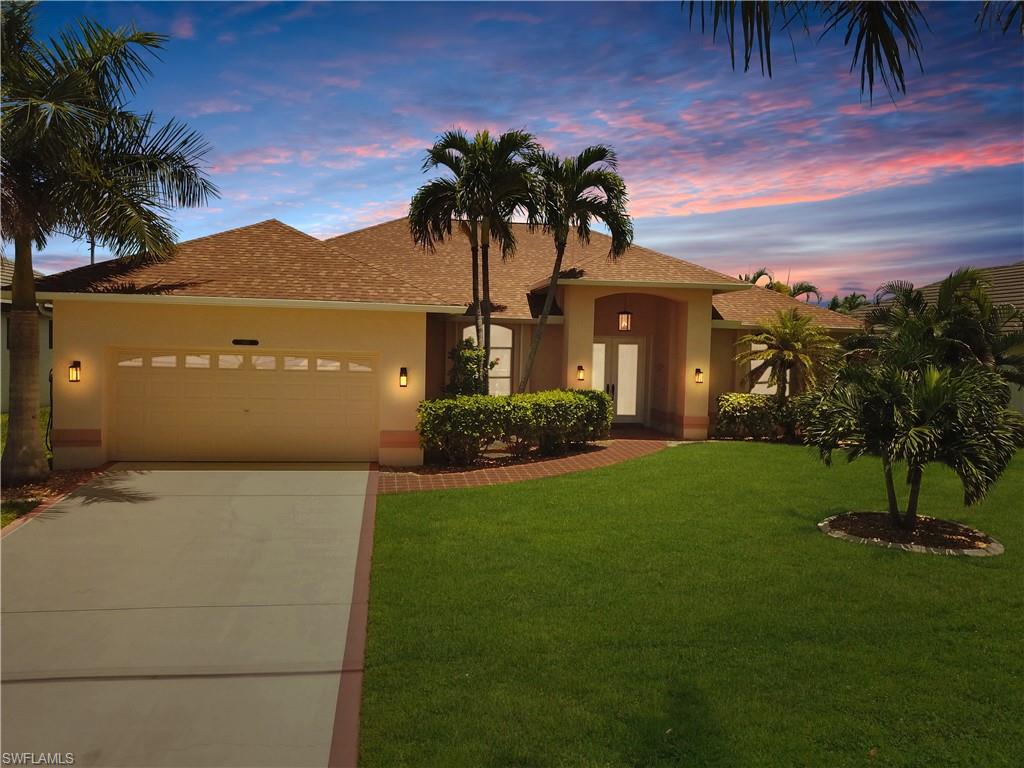 HOLY SMOKES! This home is not going to last long! Welcome to the tropical oasis of 2601 SW 37th St. Located in the highly sought after are of SW Cape Coral, this Gulf Access property is a boaters paradise. Situated on a wide 140ft canal, enjoy endless views lounging on your dock with a new lift system or catch some sun relaxing by the solar heated pool. When its time to cool down, retreat inside to this beautiful home where you are greeted by an expansive living room with natural light pouring through the large glass windows and doors. Enjoy the ease of walking straight into a fully furnished home with Gulf Access boating at your fingertips. This home makes sure to put every inch of space to good use. Spanning 2,045 sqft, there is plenty of interior room for entertaining, storage, and personal space. And who could forget the master bedroom which features an oversized room with a canal view and large master bathroom. Additional rooms include, 2 guest bedrooms with spacious walk in closets, an open kitchen that connects to the living room, breakfast nook with a water view, and a flex dining/living space. Pride in ownership stands out in this house. New roof installed in 2021, cleaned up and improved landscaping, updated dock and lift system, air conditioner boosted, and no carpet for easy indoor maintenance. Don't wait to make this waterfront wonderland yours today!