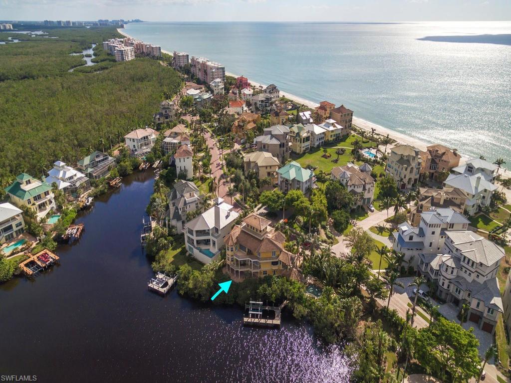 H.13806 - Walk to the Gulf of Mexico and award winning Barefoot Beach. This stunning custom home has views of the Bay from every room with panoramic Gulf views from the Observatory. This spacious 5 bedroom, 5 bath floor plan is perfect for entertaining, with gourmet kitchen, expansive balconies, resort style pool and an outdoor kitchen that seats 10 for alfresco dining. The Master Suite has a large walk in closet and gas fireplace. Impact doors and windows throughout. The boat dock is included with a 20k lift and direct Gulf access. Barefoot Beach is located in COLLIER County and one of it's most prestigious neighborhoods. The Club at Barefoot Beach is a private, member owned club offering a lifestyle of leisure, fun and a calendar of social events. The Club is located directly on the Gulf of Mexico amid several acres of tropical paradise. The Club is available but not included.