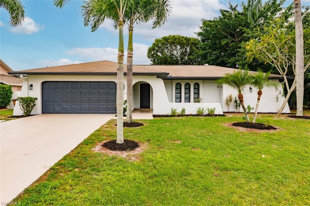 Welcome home! From the moment you pull into the driveway you will notice the fresh paint, crisp landscaping and large 2 car garage. The moment you open the door you’ll be greeted by beautiful tile floors, new trim and fresh paint throughout the home. The kitchen is equipped with BRAND NEW Stainless Steel appliances. Kitchen features granite counters, subway tile backsplash and a peninsula for entertaining. Both bathrooms have been recently updated and feature all new vanities, toilets and black hardware. The spacious floor plan features a split layout with a formal living room and dining room. Off the kitchen is another area for eating and as well as a 2nd living room with amazing vaulted ceilings. The large master bedroom and bathroom are located on one side of the home for privacy while the additional bedrooms are on the opposite side of the home. The backyard features a covered lanai that overlooks the fenced in backyard which has plenty of room for a pool! Additional features include all new blinds, fans, hardware and recessed lighting throughout. New garage door opener and water heater. Located in a highly desired and established  neighborhood that is near everything from shop