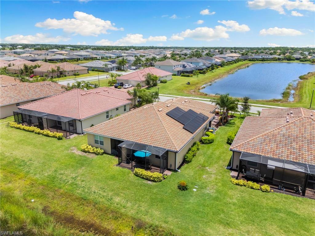 Fully Paid-Off Solar Panels, a Paid-Off Whole-Home Water Treatment System, and a Custom Screened Garage Enclosure define the exceptional value of this North Naples residence. Located in the gated community of Orange Blossom Ranch, this home is engineered for modern efficiency and reduced monthly overhead. By combining low-maintenance living with these significant, already-installed upgrades, this property offers a rare turn-key financial advantage for the discerning buyer.

Positioned on a premium double lake lot in the sought-after 34120 zip code, this Orchid model features a unique architectural orientation. You will enjoy unobstructed western sunset views from the front of the home and peaceful, tranquil sunrises over the water from your extended covered lanai. The open-concept, 1,544-square-foot floor plan includes two bedrooms, two full bathrooms, and a versatile den, all finished with durable tile flooring. The kitchen has been elevated with a custom tile backsplash and automated under-cabinet lighting, creating a perfect environment for entertaining.

This home is designed for the Florida lifestyle, featuring a custom screened garage enclosure that invites refreshing cross-breezes through the home, significantly reducing the need for artificial cooling. The exterior has been enhanced with professionally redesigned, mature landscaping, providing a lush garden setting that offers superior privacy compared to standard neighborhood plots. For total peace of mind, the property is fully outfitted with a comprehensive Ring security system.

Orange Blossom Ranch is a premier, golf-cart-friendly community featuring resort-style pools, fitness centers, and active sports courts. Its value is further anchored by its location in a high-growth corridor; the newly completed Vanderbilt Beach Road extension ensures rapid access to Gulf of Mexico beaches, downtown Naples, and premier shopping. With proximity to the new regional waterpark and upcoming commercial developments, this home is perfectly positioned in the most dynamic area of Southwest Florida. If you are looking for a property that balances luxurious waterfront living with long-term financial foresight, this home is the definitive choice. Schedule your private showing today.