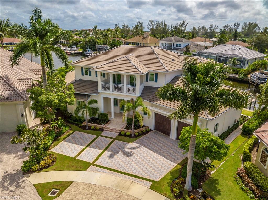 ENJOY THE FINEST IN COASTAL LIVING! This home features high quality construction with top notch fit & finish from the hardwood & travertine flooring, to the millwork & trim, to the high-end Wolf & Subzero appliances, to the Andersen windows & ceiling details. This Coastal Contemporary design is Green Certified (all LED lighting) and features disappearing pocketing sliding doors, hidden A/C vents, fireplace, LED pool & spa with multiple light options. It is also a smart Home with Control 4 computer controlling all lights, HVAC, cameras & pool. All can be controlled from a phone. Enjoy stunning wide & long water views from this tip lot location with 163’on the water that offers quick, direct deep-water access to the Gulf from your extensive dock that has a 20,000 lb. lift (42’ boat) and a 22’platform lift for your waverunners. This desirable Tigertail location is also within walking distance to the beach. This Smart Home residence has it all and is the new standard in Coastal Contemporary luxury living on Marco Island.