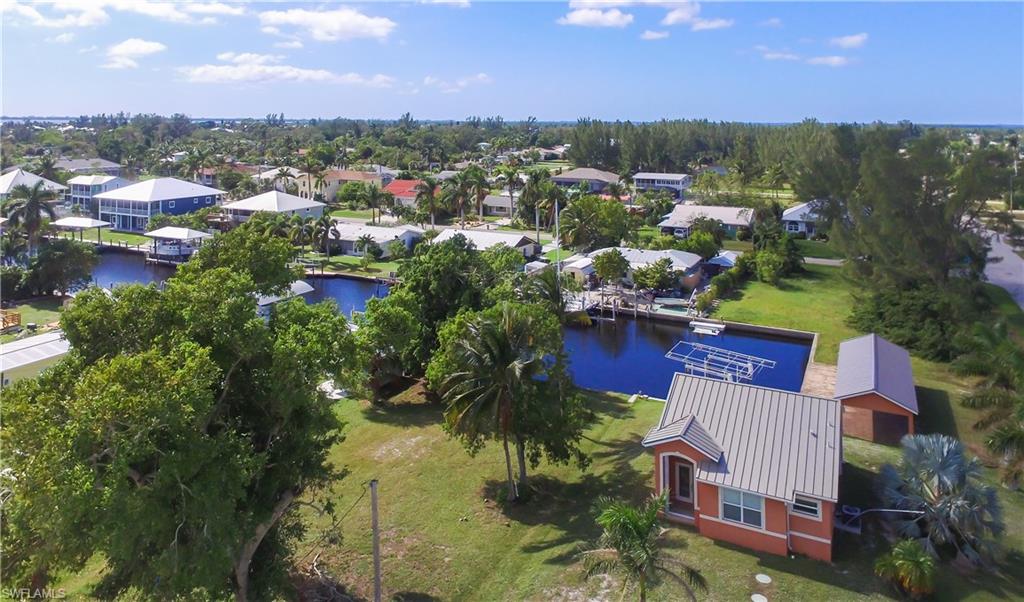 Not your typical Pine Island Bungalow ! Stunning newer construction home in sought after St. James City. Don't let the square footage fool you. Property features include Vaulted ceilings, Designer Kitchen, Premier Solid Wood Cabinetry, Stainless Appliances and Tile Flooring throughout. Screened Lanai overlooks the water. Amazing Party Pavilion with relaxing view down the wide canal. Bring your Boat and fishing poles. Sold Turnkey with beach inspired furnishings. On Demand Efficient Hot Water. Garage is 15x24, Carport 15x24, Party Pavilion 10.5x52.