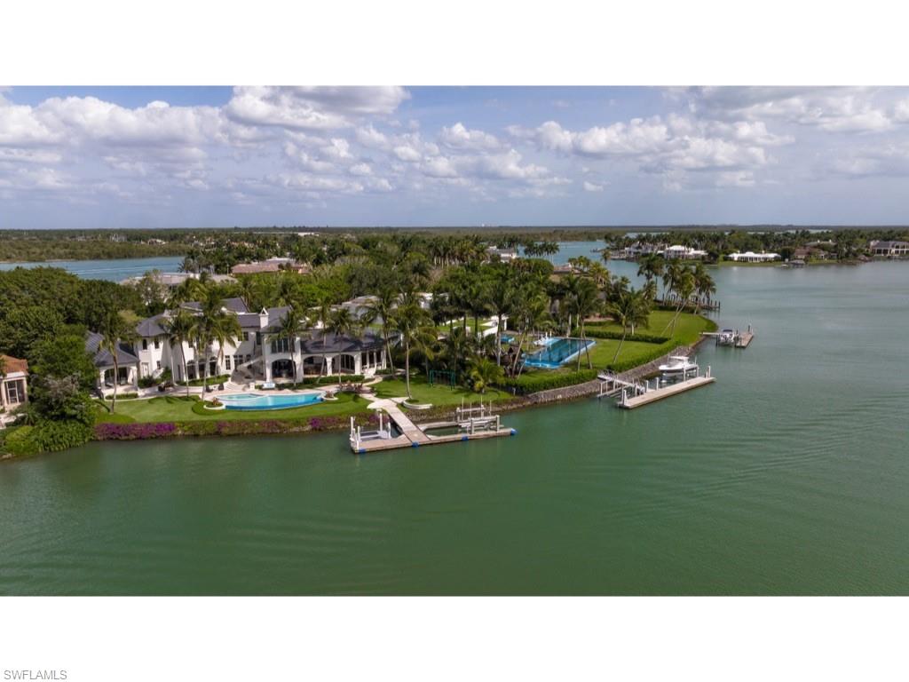 At a time when inventory in Port Royal is extremely limited, a rare opportunity to purchase a property with one of the finest waterfront views in all of Port Royal is now available! Situated on a large lot and one half, this exquisite estate has panoramic views over the wide waters of Galleon Cove, a most sought after location within Port Royal. Superb taste is manifested throughout with remarkably detailed elements of stonework and rich wood. Creatively designed by Harrell & Co. Architects - Florida, Inc. and built by BCB Homes, Inc., the home’s numerous “shore parallel” rooms take full advantage of the exceptional western views. Approximately 207 feet of water frontage per the plat and/or deed. An impressive primary suite is located on the first floor. There are 4 additional guest bedrooms in the main residence and a "self-sufficient" 5th guest suite with its own exterior entry. 6 garage bays and large motor court. Elegant grounds and verdant landscaping are complimented by a significant concrete floating dock and lifts. Port Royal Club membership eligibility.