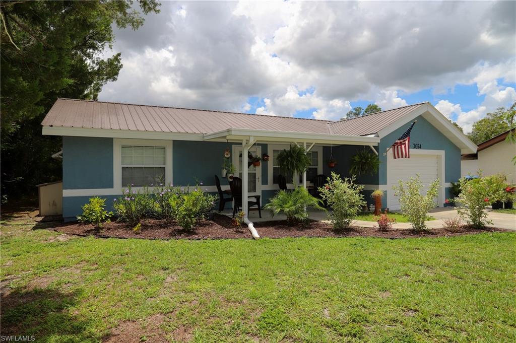 This charming 2 bedroom 2 bath home in Country Village is perfect for first time homeowners, retirees, or an investment rental. Only 1 owner since 2004. The interior & exterior are very well maintained, one of the nicest homes in the neighborhood. The good size back yard connects to a huge greenbelt (grassy expanse designated as a no build area). The office & dining areas connect to the cozy family room. The galley style kitchen has stainless steel appliances, a pass-thru window, smooth-top range, tiled backsplash & a dine-in area. There are 2 large bedrooms & 2 tiled bathrooms (master: large tiled shower, guest: combination tub & shower). There's a spacious screened lanai & cute front porch, come take advantage of LaBelle's great weather & fresh country air! The 1 car garage has an automatic door opener and washer & dryer hookups. The entire house has either floating wood or tile floors! This home has lots of charm and character! The HOA fees are very low, $374 per year, that allows the use of the community pool, clubhouse & outdoor RV/Boat storage. The AC has been serviced regularly and has a brand new air purifier. The metal roof is only 7 years old. Window coverings included.