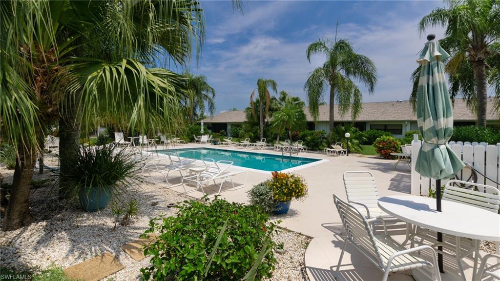 Rare pool villa available with an even more uncommon lake view! THERE ARE VERY FEW VILLAS WITH A LAKE VIEW AND A POOL RIGHT IN YOUR BACKYARD. You get the best of both worlds. This beautiful unit has everything you need and is being sold turnkey. Very open, comfortable and spacious with both the front and back lanais enclosed for year round enjoyment. Beautiful new laminate wood floors in the main living area and bedrooms. Many updates including newer water heater, washer and dryer, range, refrigerator, dishwasher, garbage disposal, plantation shutters in the master bedroom and tile on the front and back lanais. The new roof was just installed in the spring of 2020. Cinnamon Cove is a very active community with resort style amenities including a full time activities director, clubhouse, 4 community pools, tennis and bocce courts, fitness center, library, and 3 lakes for fishing. This gated community is located just 3 miles from white sandy beaches, and close to restaurants, shopping, golf courses, and all the wonderful things SW Florida has to offer.  Priced to sell...so hurry on this one!