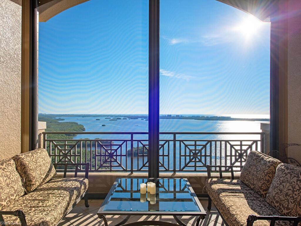Opulent one floor Penthouse living with lavish design pays homage to palaces and notable estates from the past. Extravagant doesn’t begin to describe this 20th floor sky home sitting atop the amazing waterfront La Scala at The Colony Golf & Bay Club. At almost 8000 SF (includes extensive lanais) home includes 5 bedrooms, 6.5 baths, intricate coffered ceilings, marble and wood floors, 11+ft ceilings and walls of sliding glass doors that bring in southwestern sunset views over the Gulf of Mexico. Custom kitchen has gas cooktop, two dishwashers and views forever through large picture window. Owners suite features entry foyer, luxurious closet and two separate bathrooms. The four remaining en-suite guest rooms provide privacy and ample space for large gatherings of family & friends. Unit includes its own private two car garage and AC storage.  La Scala owners enjoy two levels of amenities including:  two story formal space, billiards room, board room, theater, and library. The fitness center and tranquil pool/spa are luxury sized for only 64 owners. Feel secure with staffed front desk 24/7. Colony amenities include: Bay Club dining, island beach park and equity golf at Colony Golf Club