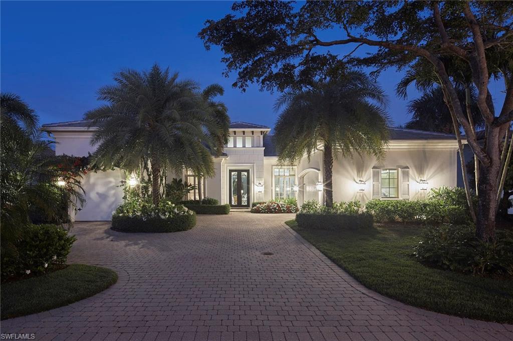 Welcome to this beautifully updated residence, positioned on a premium homesite with breathtaking long-range lake views in the exclusive Miramonte neighborhood of Grey Oaks Country Club. This four-bedroom plus study home showcases a sophisticated blend of elegance and comfort, featuring a combination of neutral stone flooring and wide-plank Francois & Co. French Oak wood floors throughout. Upon entering through striking double metal doors, you’re immediately drawn into the inviting living room, highlighted by coffered backlit ceiling, a gas fireplace and a dramatic picture window that fills the space with natural light, setting the tone for the exceptional design throughout. The fully reimagined kitchen is a chef’s dream, complete with custom Woodmode cabinetry, premium Wolf and Sub-Zero appliances, quartzite countertops, a large center island, an under-counter wine refrigerator and custom walk-in pantry. The space flows seamlessly into the expansive family room with impressive 14-foot ceilings, creating an ideal setting for everyday living and entertaining. Four-panel pocketing sliding glass doors open to a spectacular outdoor living retreat. Here, you’ll find a freeform style, natural gas-heated pool with raised spa and sun shelf, surrounded by spacious covered lanai with a cypress wood ceiling, a linear gas fireplace and a fully equipped outdoor kitchen with grill, sink and refrigerator. A newer screen enclosure with picture window panels frames the tranquil, panoramic lake views. Additional highlights include a convenient wet bar with beverage refrigerator with icemaker, and wine storage, new flat tile roof (2025), Kohler whole-house gas generator, impact-resistant windows and doors, a climate-controlled two-car garage plus a separate full-size single car complete with storage cabinets, utility sink, tankless water heater and Halo whole-house purification system. Residents of Grey Oaks enjoy an unparalleled lifestyle with access to three championship golf courses, world-class amenities and proximity to Naples’ renowned dining, upscale shopping and pristine white sand beaches.