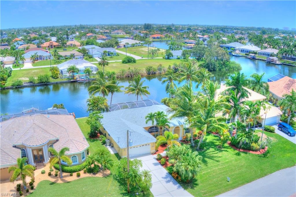 The POTENTIAL UPSIDE on this SW Cape, gulf access pool home is unlike any other home in the area - by a long shot! For any gulf access pool home over 2,000 SF in the desirable Unit 74 of SW Cape Coral, this is the lowest priced by $225,000! Roof was replaced in July, 2022. Offering beautiful morning sunrises over a 170 Ft wide canal, this home offers the absolute best outdoor living exposure - tons of sun on your pool while still providing ample shade during the high heat of the afternoon sun. This home offers a flexible layout with multiple living spaces. Due to the flexibility of the layout, it would have great potential as a vacation rental. It offers a large covered outdoor living area that is accessible by 3 sets of sliders (incl. pocket sliders) & all living areas offer canal views. Listed at an As-Is price, reduced $150,000, with an estimated $40,000 +/- to bring it back to pre-Ian condition (replace lanai cage & minor shingle replacement). Additional savings built-in for updating interior. NO WATER INTRUSION, NO FLOODING and NO ROOF LEAKS FROM IAN! Simple repairs and cosmetic updating turn this home into a show stopper - for less than any comparable home in the area!