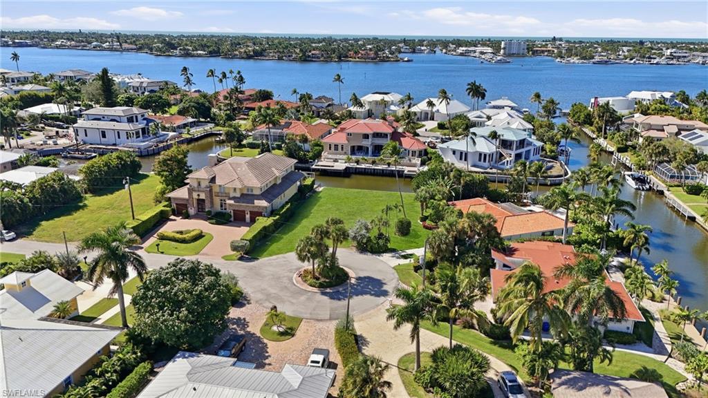 A prime waterfront homesite at the end of a quiet cul-de-sac in Royal Harbor, one of Naples' most storied and sought-after boating communities. Positioned where the canal meets intersecting waterways, 1510 Mullet Court offers 115 feet of water frontage and direct, bridge-free access to Naples Bay and, beyond it, Gordon Pass and the Gulf of Mexico.
This is a site engineered for the serious boater and discerning builder alike. Whether you envision a sportfish yacht, a center console, or a pair of jet skis, the deep-water canal accommodates it all — with ample frontage for a full boat lift, jet ski lift, and a custom dock designed exactly to your specification. Western rear exposure means the pool deck and outdoor living area will be bathed in shade for morning coffee and drenched in the legendary Naples sunset palette every evening.
On 0.22 acres, there is generous room for a thoughtfully designed luxury abode with resort-style outdoor living — the kind of home that Royal Harbor's ongoing transformation has been celebrated for, as grand new custom residences have steadily replaced the neighborhood's original homes. The blank canvas here is rare: no tear-down costs, no demo delays, just a shovel-ready opportunity to build precisely what you've envisioned.
And the location could not be more central to the Naples lifestyle. Fifth Avenue South's boutiques, galleries, and award-winning restaurants are a short bike ride away. The white-sand beaches of the Gulf are just minutes by land or water. Tin City, the Botanical Garden, Cambier Park, and Windstar Country Club are all within easy reach. This is your invitation to claim a great building site in a community where trophy waterfront homes regularly trade above $10 million.