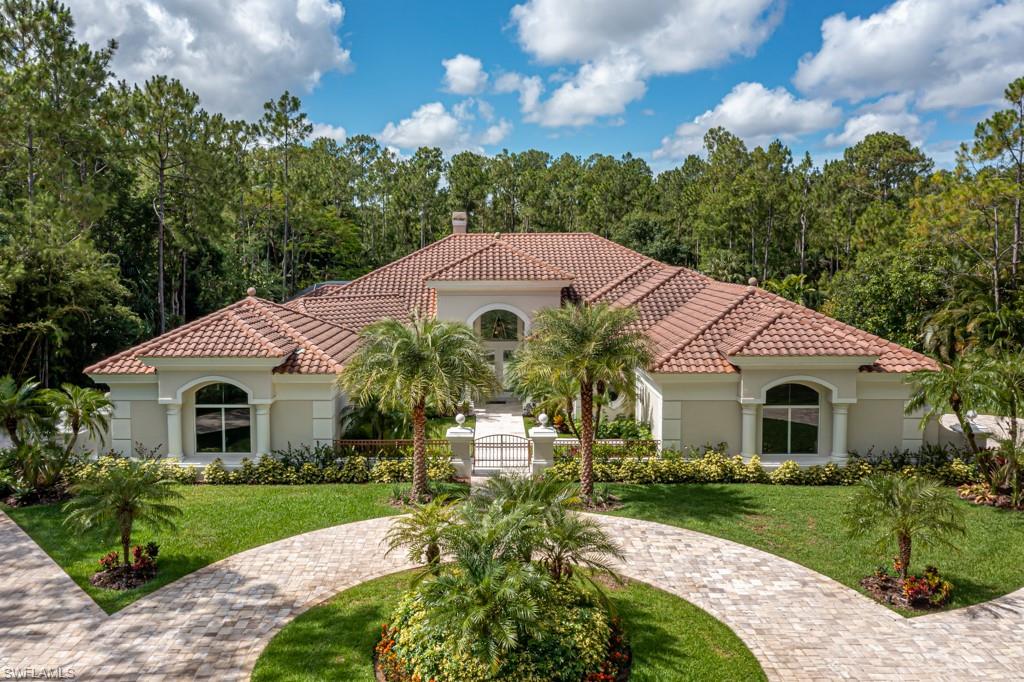 IMPRESSIVE, EXQUISITE, INCREDIBLE!! THIS IS A ONE OF A KIND PROPERTY IN HIGHLY DESIRED WEBER WOODS!  Close in, this beautifully furnished home, is the finest estate home available in the Golden Gate Estates/North Naples area.  Newly remodeled, this home, built by Arthur Rutenberg, boasts 4 bedrooms, 5 full bathrooms, a den/wine room with Llebharr wine refrigerators, a master suite with an extra sitting area/exercise room, a dressing area and two very large walk-in closets with built-ins.  A large kitchen with an oversized island and high-end Dacor and Miele appliances, connected to the very large family room, makes this area of the home perfect for entertaining.  Enjoy your extremely large covered lanai around the pool and spa while you grill using your outdoor kitchen or sit out by the Koi pond and enjoy the beautiful landscaping throughout the property.  Even the most discerning buyer will realize how special this property is!