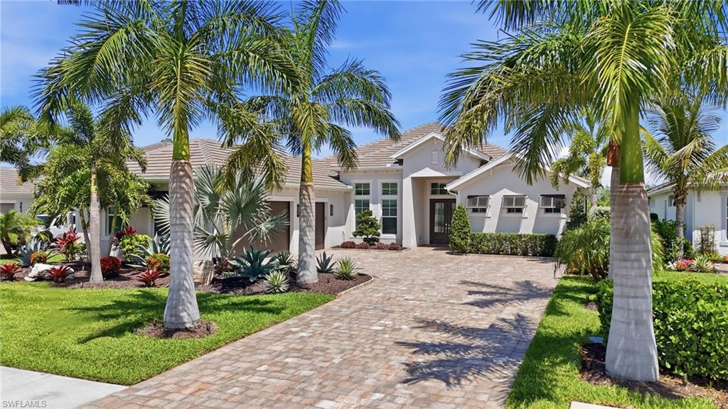Welcome to 18902 WildBlue Boulevard, an exceptional luxury residence in the prestigious WildBlue community where refined design meets breathtaking natural beauty. Perfectly positioned on a tranquil canal with protected preserve views, this professionally designed and decorated home offers a rare combination of privacy, elegance, and the ultimate Southwest Florida lifestyle.
From the moment you enter, you are greeted by sophisticated finishes, thoughtful upgrades, and impeccable attention to detail throughout. Expansive living spaces are enhanced by designer lighting, custom millwork, elevated fixtures, and a seamless open concept layout ideal for both everyday living and entertaining. Walls of glass invite abundant natural light while framing serene water and preserve vistas that create a true indoor outdoor experience.
No detail was overlooked in the extensive list of luxury enhancements, including upgraded professional landscaping with decorative lighting, drains connected to all gutter downspouts, garage shelving and custom storage systems, and an air conditioned garage. The gourmet kitchen has been beautifully upgraded with upper cabinetry, upgraded appliances, designer kitchen hardware, and a frosted glass pantry door.  The great room features a custom built entertainment wall with fireplace, creating a sophisticated focal point for the home. 
Outdoor living is equally impressive with a custom saltwater pool and spa featuring an autofill system, all surrounded by upgraded porcelain pool decking that enhances the home’s resort style atmosphere. The lanai showcases a custom built in entertainment wall with mounted TV, fireplace, and marble tile feature wall, along with a richly detailed wood ceiling and tranquil canal and preserve views that provide the perfect backdrop for relaxing or entertaining year round. 
The luxurious owner’s suite offers a private retreat with spa inspired finishes and peaceful views, while guest accommodations provide comfort and style for family and visitors alike.
Additional premium upgrades include a whole home water treatment and conditioning system with reverse osmosis at the kitchen sink, exterior decorative shutters, custom bathroom mirrors extended to the ceiling, floor to ceiling custom tilework in every shower, designer lighting fixtures throughout, and countless additional enhancements that elevate this residence far beyond builder grade. 
Located within WildBlue, residents enjoy access to world class amenities including over 800 acres of boatable lakes, resort style pools, fitness centers, tennis, pickleball, dining, and an extraordinary Southwest Florida lifestyle.
18902 WildBlue Boulevard is more than a home- it’s a statement of luxury living that you have to see in person to truly appreciate.