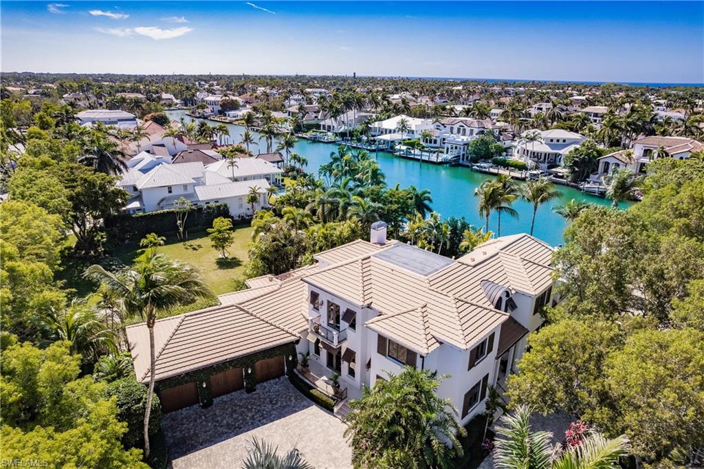 Coastal Estate with Deep Water Gulf Access – No Hurricane Damage

Ideally positioned on the corner of 8th Street and 18th Avenue, this exceptional coastal estate enjoys beautiful wide water views and is just steps from the beach and the vibrant shops and restaurants of 3rd Street South. The home sustained no hurricane damage—not to the house, garage, docks, or boats.

Designed by the acclaimed Kukk Architecture & Design (Jon Kukk), this impressive residence blends timeless luxury with unmatched functionality. Boasting 5,852 square feet under air and 7,964 total square feet, the home is a haven for both boating and car enthusiasts.

Inside, you'll find elegant architectural details throughout: soaring ceilings, custom crown moldings, wide baseboards, and rich marble and wood flooring. The gourmet kitchen will impress even the most discerning chef with top-tier appliances, two dishwashers, a new refrigerator, a country kitchen, and a second master bedroom.

The first-floor master suite is a private sanctuary, offering spacious his-and-hers walk-in closets and a striking vaulted octagonal alcove. The luxurious bath includes dual vanities, a dressing table, and a reclining spa tub.

Additional features include:

Anderson impact-rated exterior doors and windows

Custom mahogany front door

Granite countertops

A 630-bottle climate-controlled wine room

Lutron lighting system

French doors and refined custom millwork

Step outside to the vanishing-edge pool and spa, where you can unwind or entertain on the expansive lanai featuring motorized screens, a fireplace, and a summer kitchen—all overlooking the serene waterway.

Boating and Car Enthusiasts Take Note:

Expansive 3-bay garage with 2 lifts (accommodates up to 5 cars)

Room for 10 additional vehicles on the large paver driveway

Large dock for up to a 60-ft yacht, plus a lift and surrounding dock for a 35-ft vessel

The property also includes a fenced-in area, perfect for pets or grandchildren to play safely.

This home is a true masterpiece of design, comfort, and coastal living—offering privacy, space, and immediate access to the Gulf of Mexico.