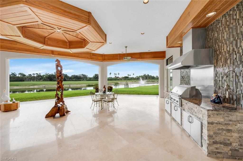 Views! Views! Views from almost every room!! A magnificent custom-designed estate, (2016), where timeless craftsmanship meets modern luxury! Showcased on one acre, overlooking the 4th fairway of Twin Eagles Golf & Country Club's revered Talon Course, this home offers sweeping views of the lake and golf course from nearly every room! An additional FOUR acres of land extend into the water and fairway, offering an unmatched sense of privacy and space. Warm, rich wood finishes, harmonized with other materials, set the tone of refined comfort and tranquility. Mahoghany and Leaded Glass doors, stained Oak trim, crown molding and solid doors, Cherry soft-close cabinetry throughout, Travertine stone gas fireplace with twisted Juniper mantel, as well as Walnut and Marble floors define the essence and character of the home.  Encompassed in 5,493sf, this ranch-style home has a sense of casual sophistication, tailored for everyday living, as well as grand entertaining. Centered around a spacious gourmet kitchen, with gas-cooking on professional-grade Wolf Appliances, including a steam oven, Sub-Zero Refrigerator/Freezer and a generous walk-in pantry, this home features 4 en-suite bedrooms, 5.5 bathrooms, a den, large game room with wet bar, two 2-car garages (4 bays) and 3 zoned HVAC systems, to mention a few. Upgrades include a whole house generator, hurricane impact glass throughout, plus electric shutters and screens for the oversized patio, for added comfort and security. Twin Eagles Golf & Country Club is abundant in wildlife and natural beauty. Residents often spot deer, wild turkeys and a variety of birds throughout the community. The Club offers a wide range of amenities, including golf, tennis, pickle ball, bocce, a fitness center with classes, a variety of hobbies, dining and social activities, for members to enjoy. Club membership is mandatory and the new homeowners can choose from golf, sports or social membership.