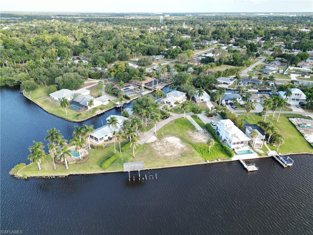 Build your legacy on the Caloosahatchee. This premier waterfront estate lot, situated at the private end of E Riverside, offers a staggering 157 feet of direct river frontage, private boat house and seamless Gulf access. Nestled within an exclusive cul-de-sac of multi-million dollar homes, the property is a sanctuary of prestige and privacy. The unique positioning allows for a custom architectural masterpiece designed to capture 180-degree panoramic views and golden sunsets from every vantage point. 
The site is cleared and ready for construction, featuring available renderings for a 3,000-square-foot luxury residence with a pool. With no assessments and a location that balances the tranquility of nearby Royal Palm Park with the high-energy dining of Downtown Fort Myers.
Beyond your personal paradise, this property presents a compelling opportunity for rental income. Waterfront homes in this corridor command premium rates, making this an investment that works whether you choose to live here or lease it out.
Properties with this level of frontage, location, and long-range water exposure are increasingly rare in Fort Myers. This is an outstanding opportunity to secure a premier waterfront parcel offering unmatched views.