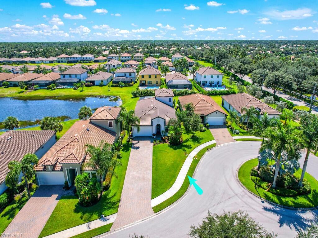 One of Raffia Preserve's best lots, situated on a cul-de-sac with long unobstructed lake views and the longest driveway in the community. As you walk into the spacious home the quality of the upgrades is evident.  This WCI Heron II model has 3 beds, 2 and 1/2 bathrooms downstairs, and the third full bathroom upstairs in the bonus room. The bonus room has many possibilities such as an office, game room, home theater, or fitness. Entertaining is a pleasure in the large open kitchen with a huge island. Enjoy the open plan living room with the custom stone wall entertainment center and electric fire feature. The large owner's suite offers a separate tub, dual sinks, large walk in shower, and custom closets.  Relax by your salt water pool and enjoy the fabulous long lake view and the landscaping through the picture window screens. No details have been spared; motorized sun shades in the great room and the master bedroom, wood paneling on the lanai and the front entry, impact windows and doors, outdoor speakers, a holiday light package, and landscape lighting.  Raffia Preserve offers a resort-style pool, a 2000 sq ft fitness area, playgrounds, basketball, and all in the A+ school zones.