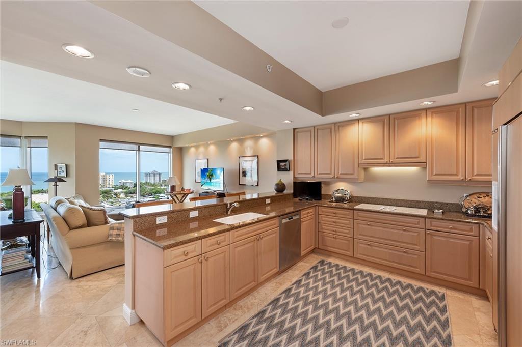 Gorgeous high-floor views and designer décor! Enter this spacious and popular three-bedroom-plus-den, three-and-a-half-bath floor plan from your private foyer into an expansive living and entertaining space highlighted by floor-to-ceiling sliding glass doors, polished travertine tile flooring and an expansive screened-in lanai with electric roll-down hurricane protection. The kitchen design features a peninsula countertop with a separate breakfast table area. The spa-inspired master bath features an oversized shower and dual vanities. Your friends and family can enjoy maximum privacy in the spacious guest bedrooms with en-suite baths. Trieste is undergoing upgrades to common areas and residents enjoy a geo-heated tropical pool, fitness room, social room, library and staffed front desk in the lobby. Experience Bay Colony and Pelican Bay beach clubs, with attended beach services or work on your serve at Bay Colony Tennis Club.