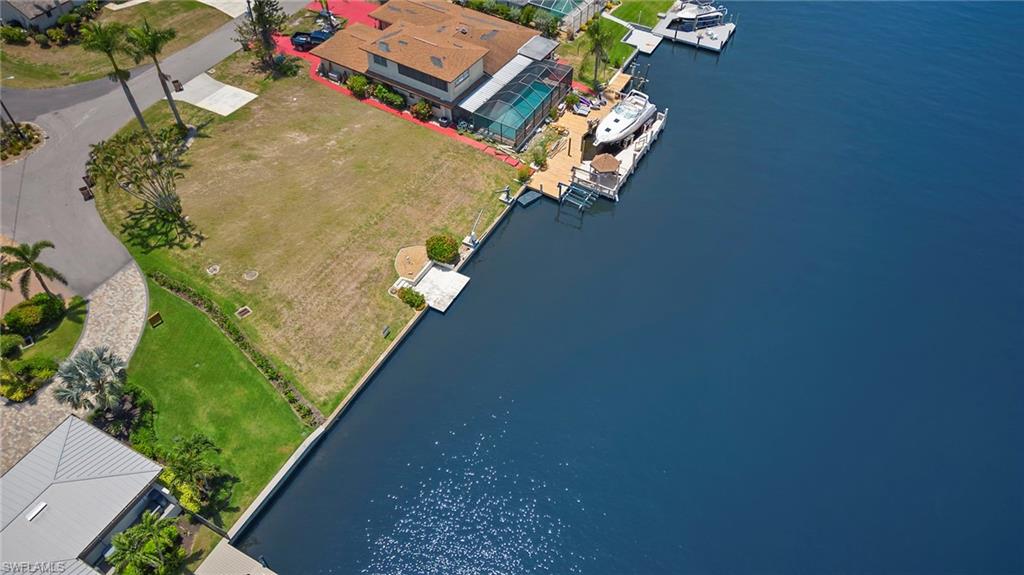 AMAZING LOCATION ON THE PALACO GRAND CANAL! Ready to spend a day at one of our beautiful beaches? This property makes it a breeze with direct Gulf access, 200ft wide, deep water canal allowing access for larger boats and sailboats. Located in the desirable Savona neighborhood, this property is perfect for the water & boat lover. No need to worry about road traffic in the neighborhood, this land sits on a cul-de-sac surrounded by million dollar homes. Centrally located between the Midpoint and Cape Coral bridge, will allow easy access for commuting to Ft Myers. Stores, restaurants, and downtown Cape Coral are just minutes away. *Please note that this property is being sold for the lot value; there is a home currently on site. Tear down and build YOUR DREAM HOME or fix up the home in place! Several pictures show what the lot looks like without the current home in place.*