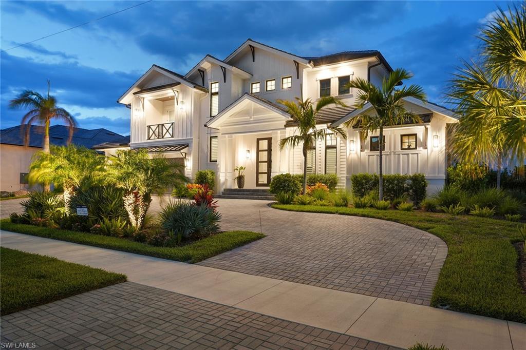 PRICE REDUCED AND READY TO SELL! This Jaw dropping  waterfront home will WOW you from the moment you walk in! Perfection at its finest! Built in 2020, this Coastal Contemporary Estates-area home has everything you could want. Foyer boasts 30' ceiling opening to incredible water views! This open concept home boasts five bedrooms, six full and one-half baths plus a den. With 4,700 square feet under air, 7,262 square feet total. European wide plank hardwood floors grace this home with 12-foot ceilings. Great room with disappearing edge doors, open to breathtaking lanai. Gourmet kitchens complete with Thermador appliances, double ovens, butler's pantry with separate wine and coffee room. Beautiful wood and metal staircase leading to family room, complete with wet bar. Adorable bunk room for the children and two upstairs en suites open to upstairs terrace with water views. The outdoor area of this home is  astounding. Multi-tiered grounds with checkerboard lawn with a 35-foot saltwater pool. Outdoor kitchen boasts built-in grill, ice maker, refrigerator and firepit. Seating areas for entertaining with drop-down shutters and screens. The lower-level dock has a firepit and seating area with 65-foot dock and 16,000-pound lift, also disappearing 6.000-pound jet ski lift. Complete with three-car epoxy floor garage and three-story elevator. This home comes furnished for your convenience!
