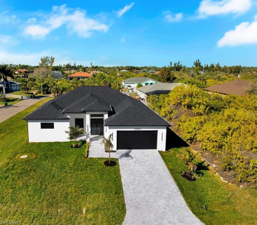 Brand-new construction with a clean, modern coastal vibe in Port Charlotte! This thoughtfully designed home welcomes you with a sleek facade, and a wide paver driveway that elevates curb appeal from the start. Inside, enjoy a bright open concept layout with large format tile flooring, recessed lighting, contemporary finishes, and an oversized chef’s kitchen featuring a statement island, modern cabinetry, and stainless-steel appliances perfect for entertaining and everyday living. The primary suite feels airy and relaxing, and the home includes a dedicated laundry area for convenience.