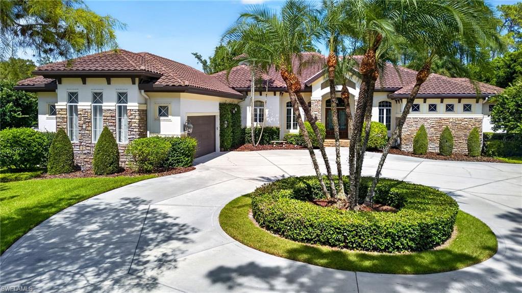 Beyond the private gates of this exceptional estate lies a resort-inspired sanctuary on 2.5 meticulously manicured and fully fenced acres. Offering 3,257 square feet under air, this 3-bedroom-plus-den home with 2.5 baths blends timeless elegance and thoughtful functionality in a private, tranquil setting perfect for both grand entertaining and everyday living.
Inside, refined craftsmanship shines through custom architectural ceilings, rich millwork, and natural stone accents. The open floor plan flows seamlessly between formal and casual spaces, anchored by a chef’s kitchen featuring a large center island that opens to inviting gathering areas with a cozy gas fireplace and sweeping views of the lush grounds. The owner’s retreat is truly spa-like, complete with a lavish dressing room and a luxurious bath boasting dual vanities, a deep soaking tub, and an oversized walk-in shower. Two generously sized guest bedrooms share a well-appointed bath, while a convenient pool bath serves outdoor living areas.
Step outside to your private resort oasis: a heated saltwater pool and spa are surrounded by tropical landscaping, expansive entertaining spaces, a fully equipped outdoor kitchen, a fire pit for starry evenings, and a fenced play area with artificial turf. A dedicated green space offers room for pets, recreation, or relaxation.
Additional highlights include an impressive concrete-and-metal-roof outbuilding with climate-controlled areas ideal for a lounge, gym, yoga studio, creative workspace, or executive office. An attached oversized garage and workshop provide ample room for multiple vehicles, tools, and projects. The property also features two additional sheds and a private shooting range—perfect for hobbyists and collectors.
Recent updates enhance peace of mind and convenience: new roof and gutters (2022), smart home system, autofill pool, replaced outdoor grill & hood, 1,250-gallon total propane tanks, hurricane screens, arena fence, 24kW Generac generator, exterior repainted, updated HVAC, 50-bird chicken coop, mini-splits in the rear garage, added asphalt around the arena, 2024 washer and dryer, and a MistAway mosquito system around the pool and lanai, just to name a few!
This rare combination of luxury, acreage living, and versatile outdoor spaces in a beautifully private setting is truly one of a kind.