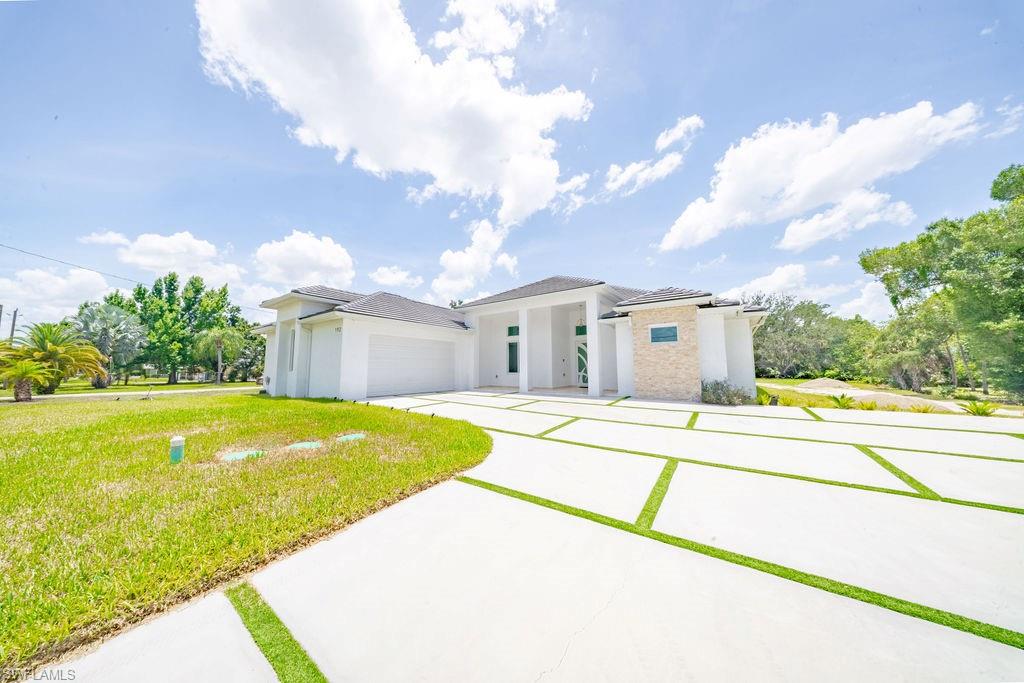 Built in 2025 on 1.14 acres in North Fort Myers, this custom home was designed for comfortable everyday living with quality construction and attention to detail throughout. Offering 4 bedrooms, 3 bathrooms, 2,324 square feet under air, and 3,734 total square feet, the home features high ceilings, abundant natural light, impact windows and doors, premium finishes, an upgraded potable well-water system, and a spacious floor plan that balances functionality with modern design.

The outdoor kitchen creates the perfect space for entertaining, weekend gatherings, or simply enjoying Florida living year-round. With over an acre of land, there’s still plenty of room for a pool, detached garage, workshop, RV, boat, or your own backyard oasis.

Conveniently located near shopping, dining, and everyday amenities while offering the space and privacy that acreage properties are known for.