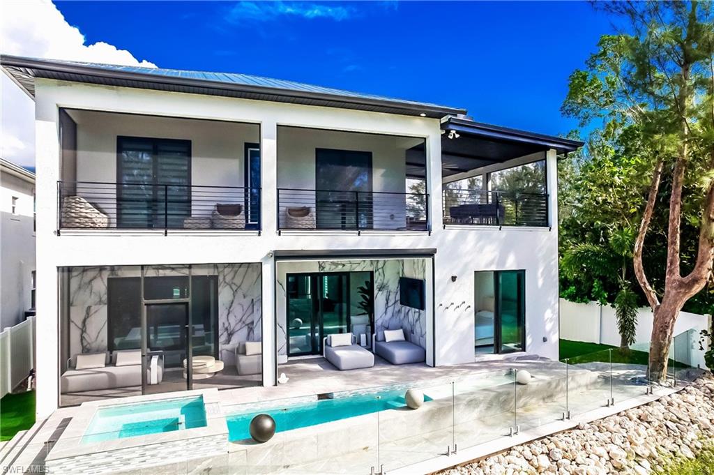 Luxury, flexibility, and freedom come together in this exceptional Naples home with no HOA. Thoughtfully designed with five spacious bedrooms, each featuring a private en-suite bathroom, plus two full kitchens, this residence combines functionality and versatility for entertaining, multi-generational living, seasonal use, or income-producing opportunities. Step outside to your own private oasis with a heated pool, spa, cold plunge, outdoor shower, and inviting spaces to relax year-round. Located in the sought-after Bayshore neighborhood, just minutes from Naples' powder-soft beaches, Fifth Avenue South, Celebration Park, the Botanical Garden, premier dining, shopping, tennis, pickleball, and boating. Equally suited as a primary residence, seasonal retreat, or income-producing property, this home has a proven track record as a successful luxury rental with strong year-over-year income, providing the opportunity to generate revenue when not in use.