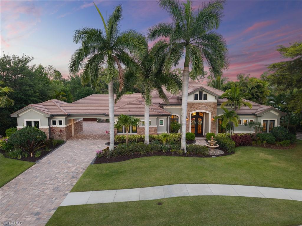 One or more photo(s) has been virtually staged, AI generated or rendered.  Stunning newer-built estate, originally a model home, perfectly positioned on a sprawling 0.65-acre lot with breathtaking golf course and lake views in Naples’ coveted Quail West community! Designed with exceptional attention to detail, this residence offers 3 bedrooms, an office, and a spacious den that can be used as a possible spillover 4th bedroom, dual garages accommodating 3 cars or 2 cars plus a golf cart, a tile roof, hurricane-impact windows and doors, and a new HVAC system (2023). Step through the grand front entry and be welcomed by an impressive foyer, elegant designer lighting, and soaring coffered ceilings. The chef’s kitchen is beautifully appointed with crisp white custom cabinetry, granite countertops, a stone backsplash, an oversized island perfect for entertaining, walk-in pantry, and high-end appliances including a gas range. Fully pocketing sliding glass doors create a seamless indoor-outdoor living experience, opening to a resort-style lanai featuring a saltwater pool and spa with water features, a fully equipped summer kitchen, a fireplace, and an expansive covered lounge area with stunning wood-paneled ceilings —all overlooking picturesque views of hole #5. The luxurious primary suite serves as a private retreat with direct lanai access and a spa-like bath complete with dual vanities, a separate soaking tub, and a spacious walk-in shower with multiple showerheads. Additional highlights include exceptional curb appeal with manicured landscaping, along with extensive exterior enhancements such as custom stonework and molding, a decorative front fountain, plantation shutters throughout, and a built-in audio system. Quail West offers an unmatched lifestyle with two championship golf courses, a 100,000-square-foot masterfully renovated clubhouse, a racquet sports complex, an indoor lagoon-style Junior Olympic-sized pool, multiple dining and social venues, a state-of-the-art fitness center with classes, and a full-service salon and spa with sauna. Ideally located just minutes from Barefoot Beach and close to Mercato, Waterside Shops, and Naples’ renowned 5th Avenue, with convenient access to both Southwest Florida International Airport and Naples Airport.