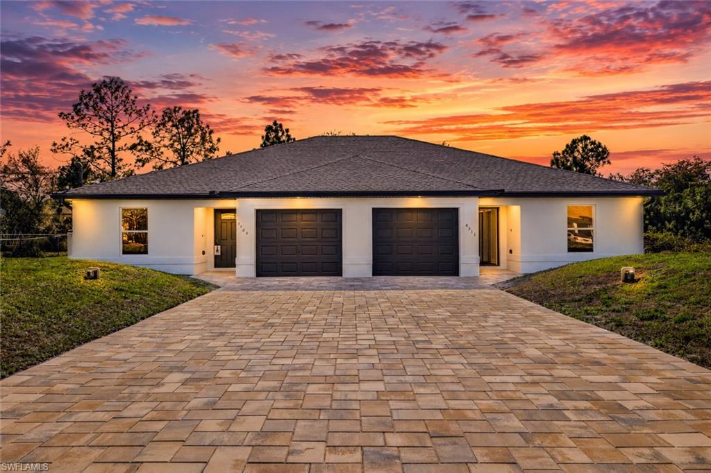 This fully renovated duplex offers a rare combination of modern finishes, functional design, and a highly desirable location just 3 minutes from Fort Myers. Situated between Daniels Parkway and Lee Boulevard, the property provides convenient access to Southwest Florida International Airport, JetBlue Park, home of the Boston Red Sox, and the rapidly growing State Road 82 corridor. Over $120,000 in improvements have transformed the property inside and out, including a New dimensional shingle roof, two New A/C systems, New hurricane-impact front doors, New brick paver driveway and New rear patios, upgraded garage doors, updated water heaters, fresh exterior paint, and New epoxy-finished garage floors. The spacious backyard backs to a canal, creating additional privacy and separation rarely found in comparable duplex neighborhoods. Inside, both units feature New wide-plank luxury vinyl flooring throughout and New redesigned kitchens with white shaker soft-close cabinetry, freestanding pantries, modern black hardware, quartz countertops, subway tile backsplashes, stainless steel appliances, modern sinks and faucets, and LED recessed lighting. Bathrooms have been fully updated with white shaker vanities, quartz counters, modern black mirrors and fixtures, maintenance-free fiberglass showers, and black rain shower heads and valves. Additional improvements include New modern ceiling fans, new interior doors with black hardware, oversized sliding doors leading to private patios, upgraded 5¼-inch baseboards, updated electrical outlets, fresh interior paint, and dedicated interior laundry rooms in each unit—a feature often missing in many duplexes. The thoughtfully designed floorplan offers flexibility for a variety of ownership strategies, including living in one unit while renting the other, accommodating multi-generational living, utilizing one side as a private home office or guest quarters, or leasing both units for strong income potential. Delivering the benefits of a major renovation without the wait of new construction, this move-in-ready duplex offers exceptional value, convenience, and versatility in one of Southwest Florida's fastest-growing areas.  This property is NOT IN A FLOOD ZONE!!!  Duplex can be sold with tenants in place prior to closing subject to negotiation.