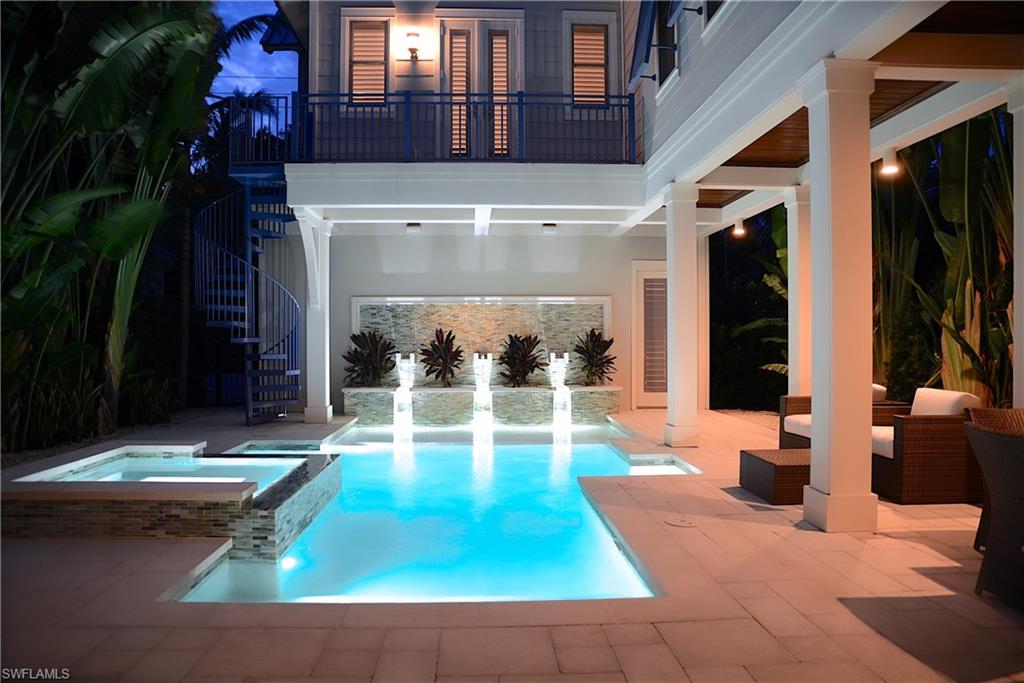 Stunning 4 bedroom 4 ½ bath home in the “Cottages on 6th”, an enclave of 7 homes located just a short stroll from shopping and dining on 5th Avenue South and the sand beaches of the Gulf of Mexico. Interior designer/owner has created a coastal contemporary theme great for casual living and perfect for entertaining and this home is being offered turnkey furnished. Endless natural light from the abundance of windows and glass and the disappearing sliding glass doors to the pool and spa along with outdoor kitchen and dining area, and access to the cabana style bedroom suite. Gourmet kitchen with Viking, Thermador and U-Line appliances, marble topped island and walk-in pantry. Private master bedroom suite with morning kitchen accessed via catwalk hallway. White washed French oak flooring, stunning centerpiece staircase, recessed tongue and groove vaulted ceilings, wainscoting, and curved metal railing, 2nd floor laundry. Quality built, impact windows and doors along with many lifestyle conveniences such as: full home entertainment, intercom & security systems, touch screen HVAC controls and tankless HW.  Gated private entry to alleyway and garages. Maintenance free living with HOA.