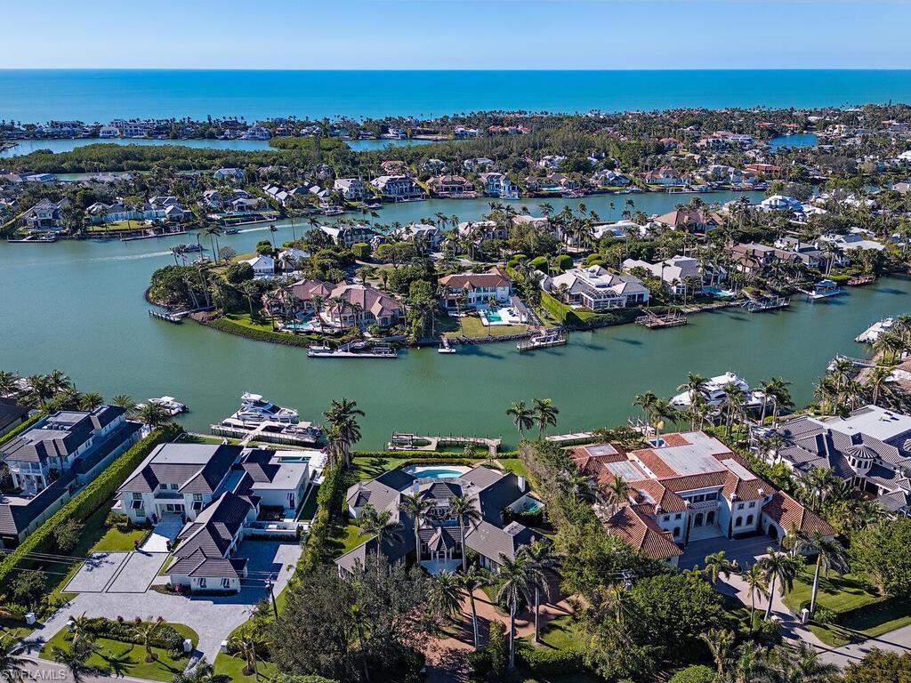 Beautiful estate home on nearly three quarters of an acre in prestigious Port Royal! This exquisite residence has 141 feet water frontage with western exposure. Boaters and water enthusiasts alike will enjoy the panoramic wide water views from the wraparound dock complete with boat lift. Homes showcases, modern design, and decor and has been completely renovated by BCB Homes. The 5 bedroom main 6 1/2 bath residence provides 7000 sqft. of living area and provides effortless flow from the interior living area to the multiple large lanais overlooking the serene pool and spa. The chef's kitchen features top-of-the-line appliances oversized island, dual wall ovens and gas cooktop. Residence sustained no storm damage from hurricane Ian and home has a whole house generator . Ideally located just minutes from 3rd Street South’s and 5th Avenue South's fine dining, world-class shopping and white-sand beaches. Port Royal Club Membership Eligible.