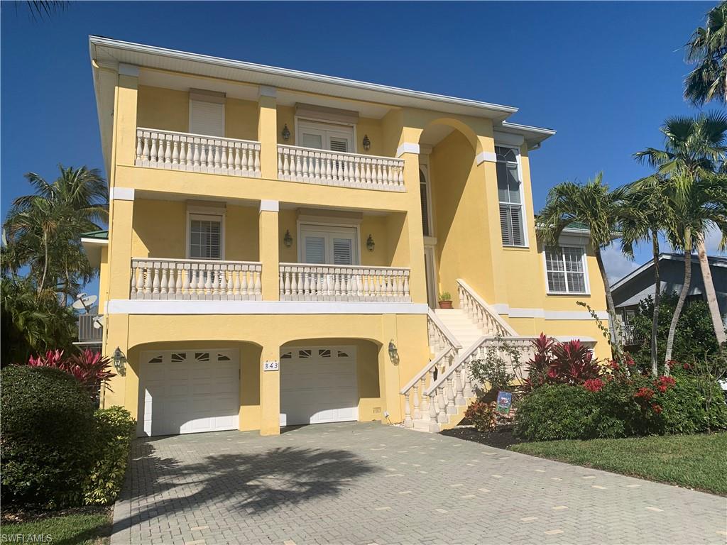 A three level 4 bedroom 3 1/2 bath home in Vanderbilt Beach with gulf access! So near the beach! Plenty of balconies front and back. Great dock area with large enjoyment/layout dock and workout sized pool plus covered boat lift. Top floor has master bedroom with bath and workout/office room. Main level is living area, two bedrooms two bath, kitchen with nice pantry, laundry room with one of the aforementioned bathroom areas, den/dining area and super high ceilings everywhere. Down a set of stairs takes you into the lower area which includes three garages (though you can probably put in a golf cart as well), lots of storage and straight out to the pool area. You can access the garages from either side through interior doors or straight outside through an under the stairs door. Out back is a winding staircase to traverse the levels from the main floor and an elevator which is currently not in use, but will be reviewed, or access the stairs. So close to the beaches, Mercato, Delnor-Wiggins State Park and so much more to see and do.