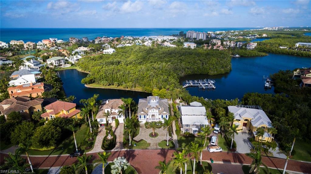 Rarely-available waterfront new construction (2018-built) by highly-regarded Windover Development. Perfectly-located in Southport on the Bay in Barefoot Beach, a double-gated North Naples/Collier County beach & boating community with deeded beach access steps away. Soak in gorgeous Bay & lake views from the entertainment deck with lounging area & in-ground pool/spa. Steps away from available private boat lift with direct Gulf access. Open floor plan with dual master suites, great room with tray ceiling accent & pocketing sliders to showcase the stunning water views. State-of-the-art features & finishes include PGT hurricane impact glass windows & sliders, Lutron smart lighting system, 6-zone speaker system with Sonos, garage with room for 4 cars, private elevator & more. Coastal contemporary with white oak floors, handcrafted lighting fixtures & designer furnishings/décor included. Chef’s kitchen with eat-in island, granite counters with subway backsplash, custom cabinetry & Thermador professional appliances. Spacious & private master suite with sitting area, its own waterfront lanai, generous His & Hers walk-in closets & spa-like en suite bath. A showcase of visionary design.