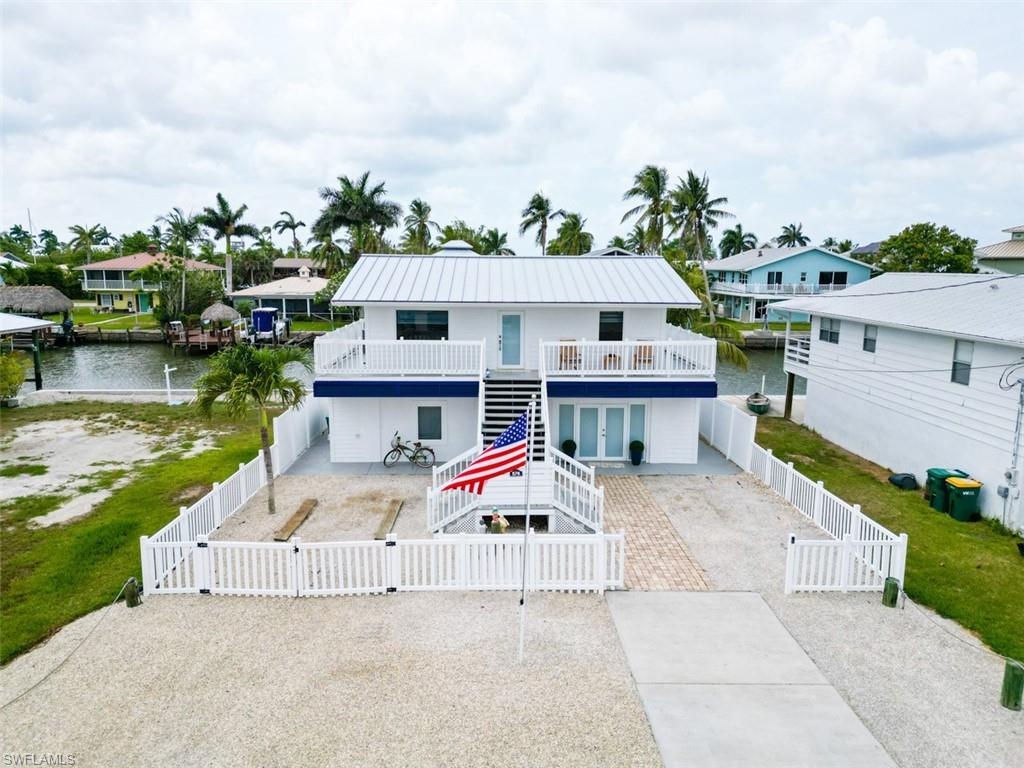 Boater's Paradise in the Heart of Goodland! Welcome to a truly one-of-a-kind waterfront gem offering coveted southern exposure and unparalleled boating convenience. This is the only home in the area featuring a private boat garage with lift located beneath the residence, making it a rare find for serious boating and fishing enthusiasts. Enjoy close proximity to Marco Island's restaurants and beaches, and available access to Residents' Beach.

Designed with functionality and lifestyle in mind, the property accommodates up to three vessels, including the enclosed boat garage, an additional dock, and space for jet skis or a combination of watercraft. Enjoy direct Gulf access with no bridges and just one minute to the no-wake zone, allowing you to be on open water in moments.

This completely renovated, solid poured-concrete home showcases premium upgrades and peace of mind throughout, including impact-resistant windows and doors and a new metal roof, offering durability, peace of mind, and long-term value. Every detail reflects quality craftsmanship and modern coastal comfort.

The upper level features an elegant main living area finished to a high standard, ideal for entertaining or relaxing while taking in the waterfront setting. The separate downstairs in-law suite, fully insured, provides exceptional flexibility: perfect for guests, extended family, or as a potential income-producing rental.

Whether you're seeking a full-time residence, seasonal retreat, or a lucrative investment opportunity, 576 Coconut Ave delivers an extraordinary waterfront lifestyle in one of Goodland's most desirable boating locations.