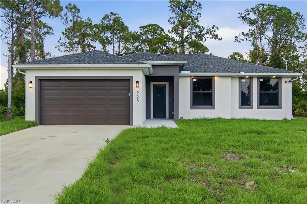 Welcome to this stunning new construction home in the growing community of Lehigh Acres! Completed in 2026, this beautifully designed 3-bedroom, 2-bathroom residence offers the perfect blend of modern style, comfort, and functionality. Step inside and be impressed by the bright open-concept layout, soaring ceilings, and elegant finishes throughout. The gourmet kitchen is the heart of the home, featuring sleek high-gloss cabinetry extending to the ceiling, quartz countertops, a stylish subway tile backsplash, stainless steel appliances, and plenty of space for cooking and entertaining. The spacious primary suite offers a relaxing retreat, complete with a beautifully appointed bathroom featuring dual vanities with quartz countertops and designer arched mirrors that add a touch of sophistication. Thoughtfully designed with quality craftsmanship and attention to detail, this home is truly move-in ready. Enjoy the convenience of a 2-car garage, an oversized driveway, and a generous lot surrounded by Florida's natural beauty. Conveniently located just minutes from State Road 82. And ideally located approximately 25–30 minutes from Fort Myers and 50–60 minutes from Naples, you'll have easy access to Gulf Coast beaches, shopping, dining, entertainment, schools, parks, and major roadways. Whether you're a first-time homebuyer, seasonal resident, or investor, this exceptional property offers incredible value and modern living in one of Southwest Florida's fastest-growing areas. Schedule your private showing today and discover everything this beautiful new home has to give you!
