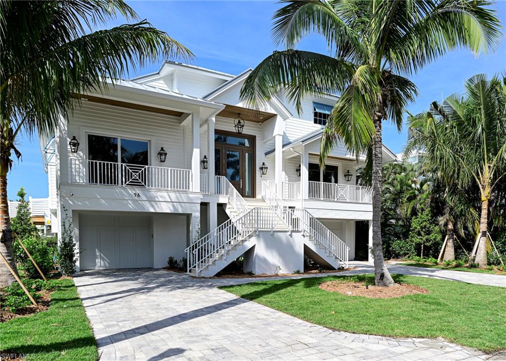 This 3 story Barefoot Beach home sits on one of the most desirable Southport on the Bay waterfront lots offering the shortest walk to the beach through the dedicated beach access, long west and south bay views plus views of the Gulf of Mexico from the main floor and 3rd floor rooms and decks. If you are a boater this home offers the ultimate dock that will accommodate a 40’ boat with lift plus another small boat or jet skis lift and even kayaks on the shore side and no bridges to the Gulf. This home was completely gutted to its shell (1999), reimagined to a 2024 floor plan and design and is Co’d in 2024, reconstructed to 2024 codes including all new, electrical, one touch lighting, plumbing, air conditioning, hot water heaters, impact windows & doors, impact garage doors, strapping, stucco including stucco siding, exterior trim, 10’ Smart Glass front door with 5 glass panels that auto frost for privacy, Gas front lights, standing seam metal roof including secondary water resistance, pool with 3 fire bowls, elevated spa including equipment, heater and deck, new exterior railings, exterior stairs, tile flooring, brick pavered driveway, all new landscaping, palm trees, sod and a whole house generator.   The interior is finished to the highest level in a light coastal design featuring 4 bedrooms 4 1/2 baths and a large open floor plan enhanced by the high volume ceilings throughout but especially in the two story wood beamed great room. There are beautiful wood accents everywhere including shiplap walls, other accent walls and ceilings including the interior of the private elevator.  Hardwood floors, custom one of a kind interior railings, all new light fixtures & plumbing fixtures, solid doors and Emtek hardware.  Kitchen offers Wolf gas range, Subzero refrigerator and freezer, microwave drawer, wine cooler, dishwasher, solid wood cabinetry, quartz countertops, brick backsplash, an oversized eat at island,  walk up bar with beverage refrigerator & sink. The large covered lanai has wide water views over the pool and includes electric screens, tongue and groove wood ceilings, gas grill with hood, sink, and large tv. All 3 Guest rooms are on the main living level with en-suite baths & king size beds finished with outstanding details plus convenient laundry and half bath. The master sits by itself on the upper living level offering the ultimate private retreat, stunning water & gulf views from the bed & open deck for private sunbathing and sunsets. The mater bath includes a shower with rain head left and right wall massaging jets and hand held faucet, a free standing tub centered on the window, his and hers separate sink areas plus vanity, a morning bar, laundry & custom closet. The covered lower lanai off the pool features a gray stone fireplace with large screen above. A 4 car garage and large lower level (finished to code). This property is offered furnished move in ready.  Southport on the Bay is a double gated community with 24 hour guard patrols.