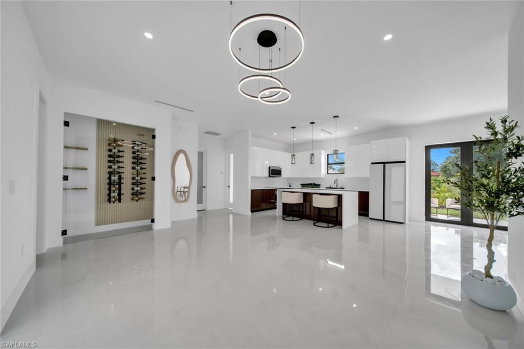 UNIQUE GEM! This brand new-construction home offers 4 bedrooms and 3 beautifully designed bathrooms. Every bedroom features custom-built closets with integrated drawers, while elegant finishes throughout the home create a sophisticated and modern feel. A custom wine display is the perfect touch for showcasing your favorite collection.The dream kitchen is the centerpiece of the home, featuring a stunning waterfall island with quartz countertops, premium cabinetry, and high-end appliances. The open-concept layout is enhanced by soaring ceilings, designer lighting, and abundant natural light, creating an ideal space for everyday living and entertaining. Additional features include impact windows and doors, a full sprinkler system to keep the lawn lush year-round, and a spacious two-car garage. Every detail has been thoughtfully designed with modern concept that combines style, comfort, and functionality.This exceptional home truly has it all. Don’t miss this incredible opportunity- this one of a kind gem won’t last long!